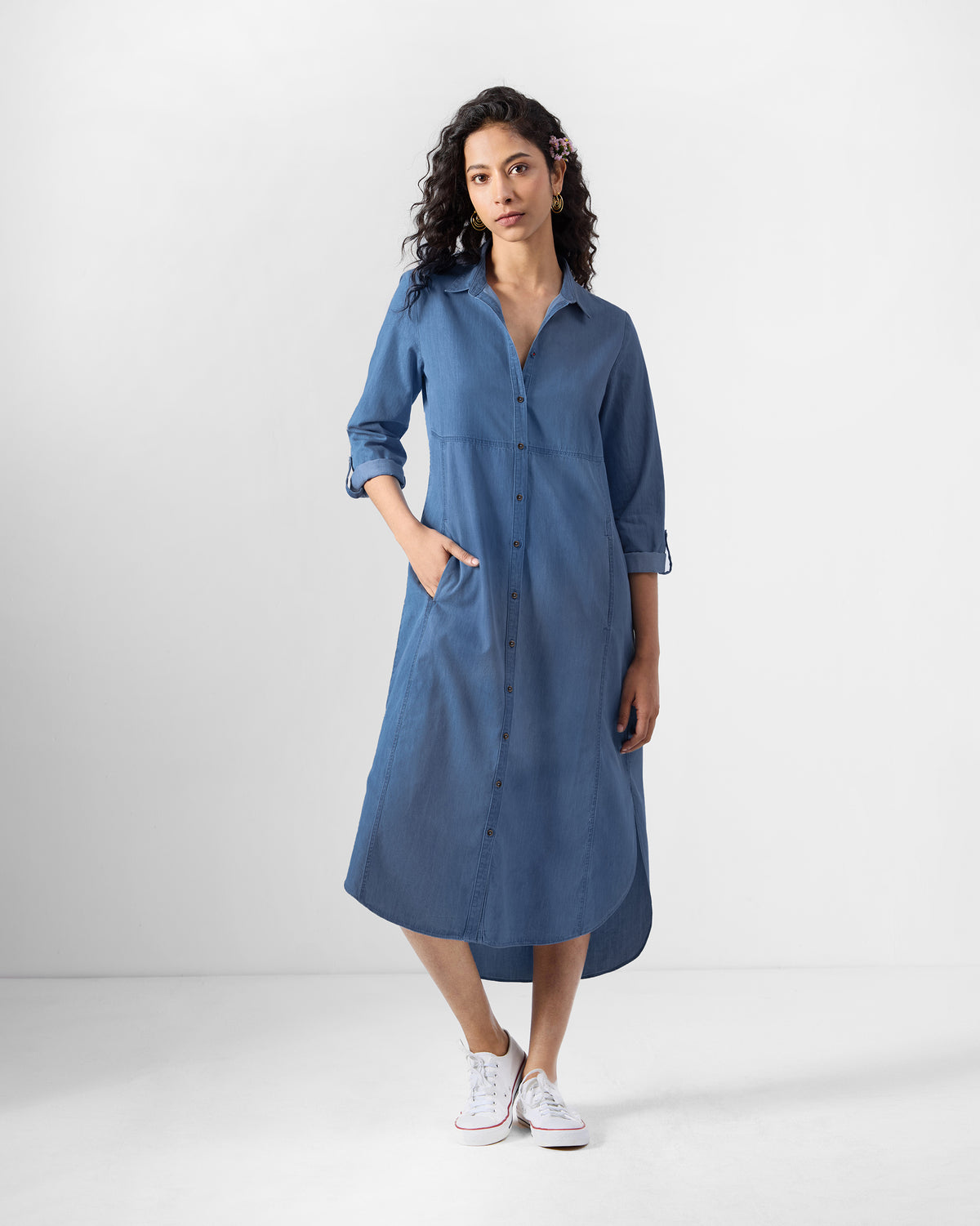 Person wearing a blue Pristine dress with a button-down front.