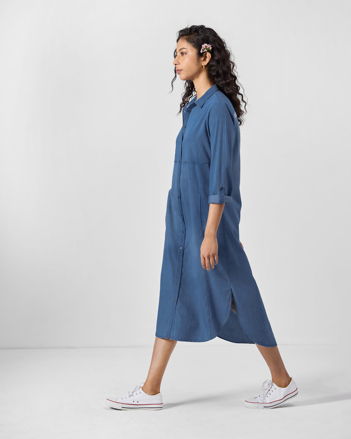 Side view of a blue Pristine dress with a curved high-low hem.
