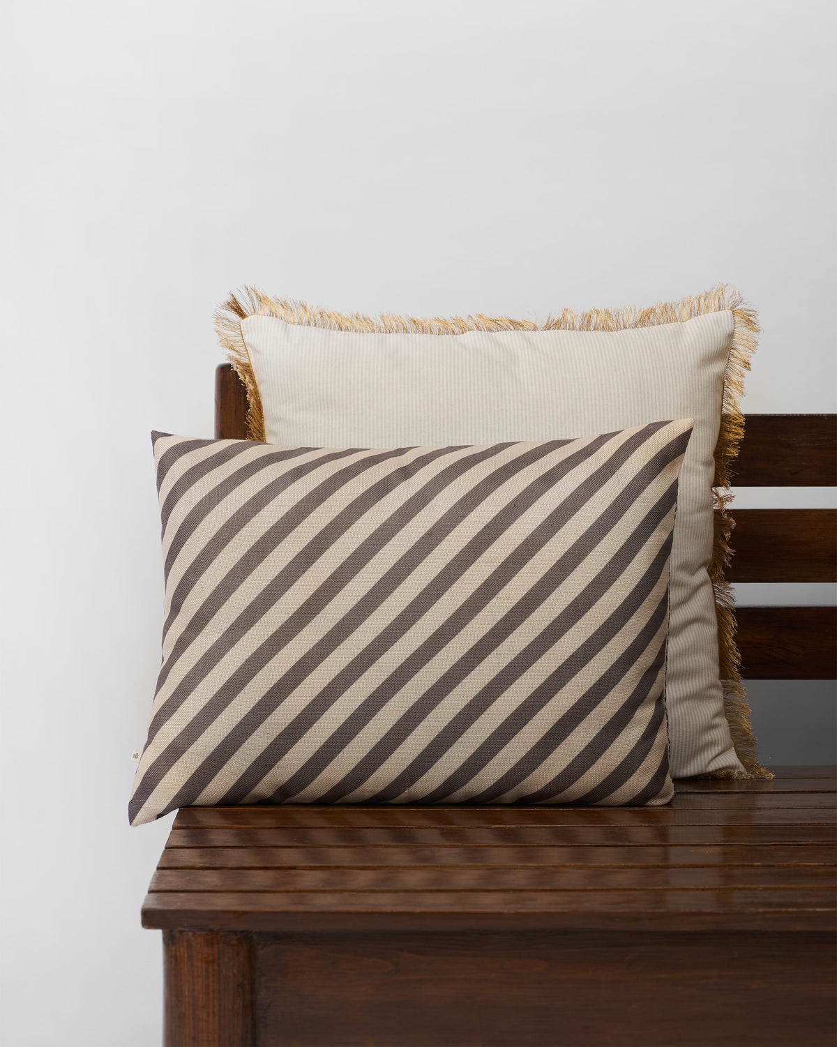 Brown and cream diagonal striped cushion cover.