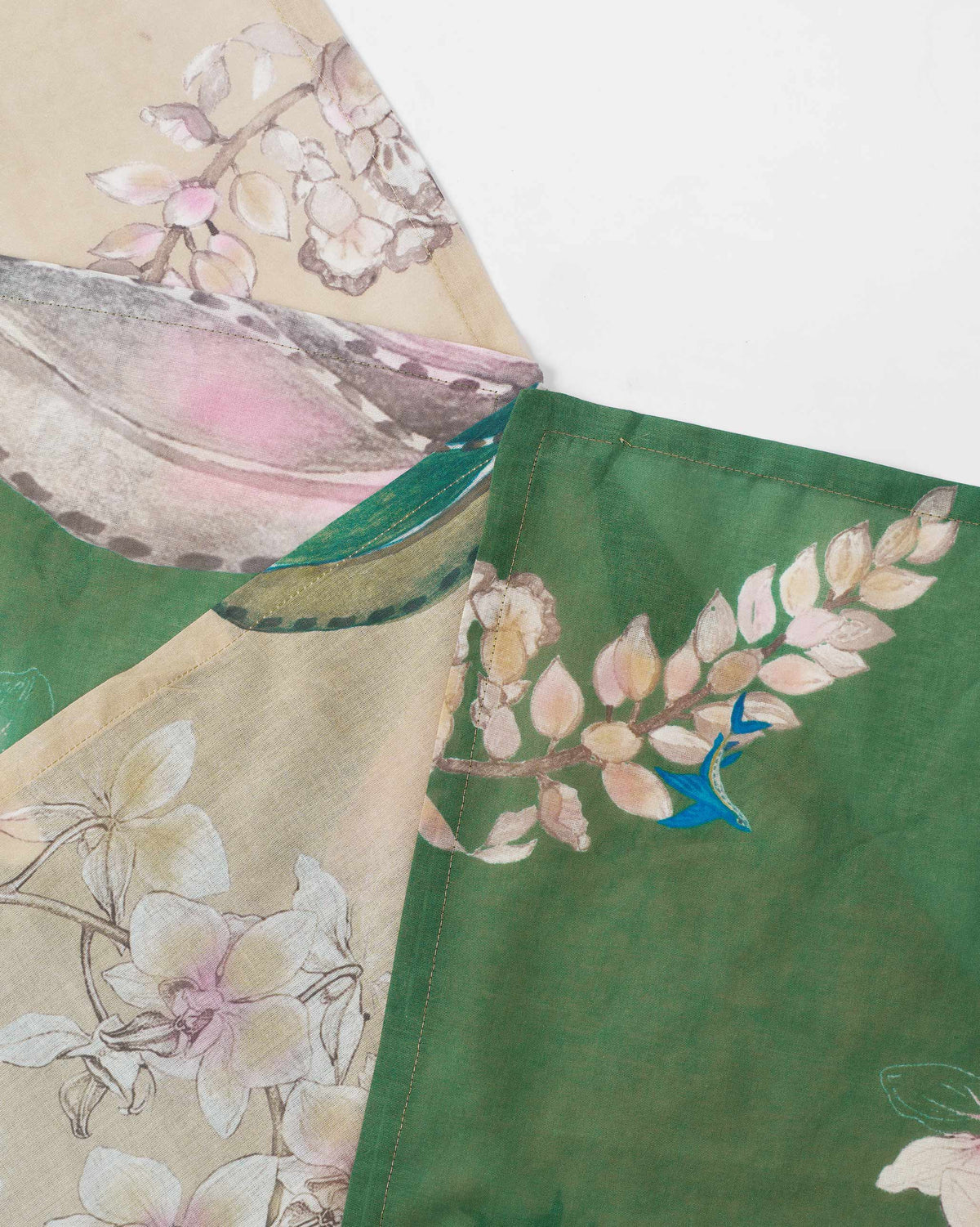 Close-up of Madhu Napkins showing their floral print and a blue bird.