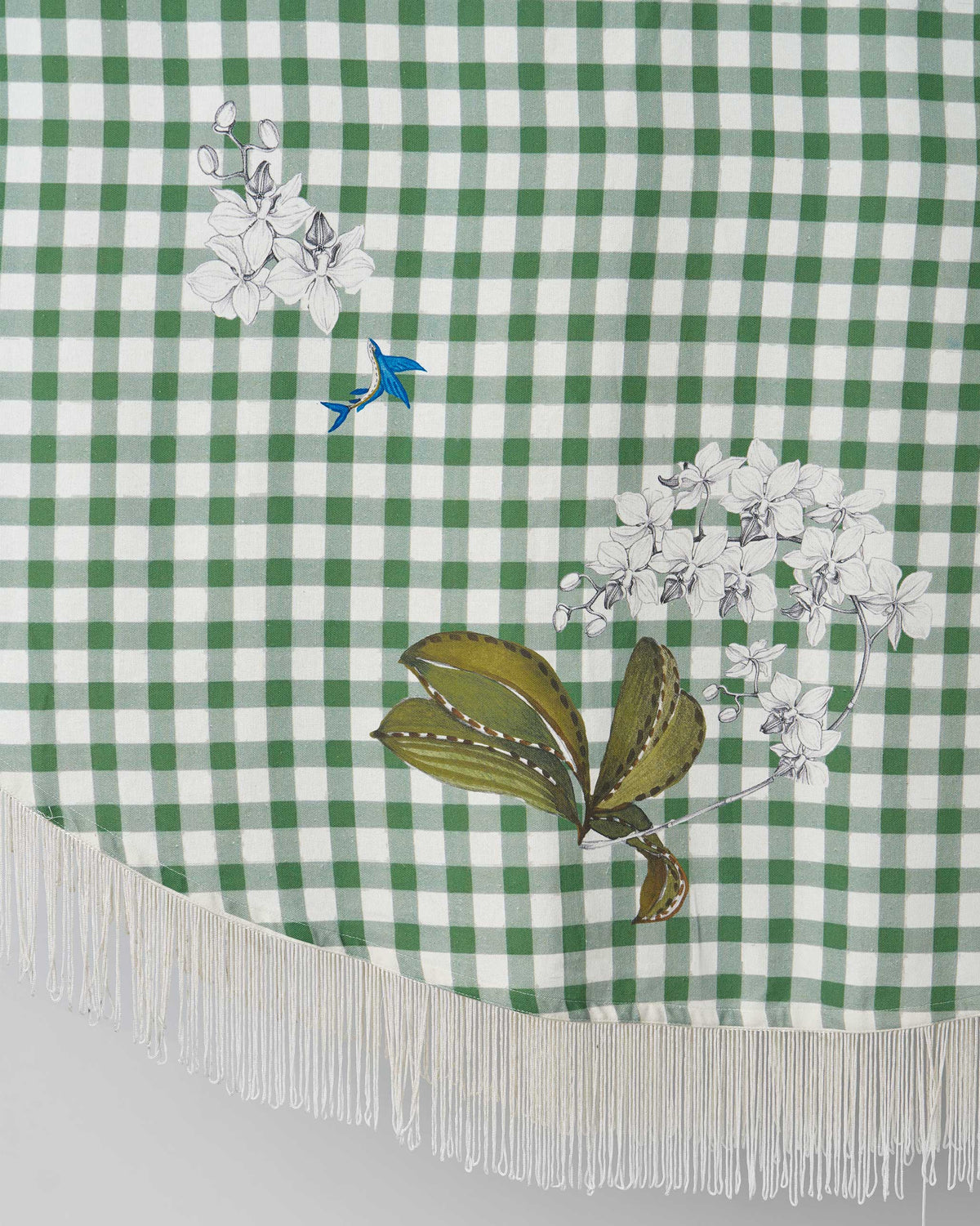 Close-up of Kaveri Table Cover showing embroidered white flowers and green leaves.