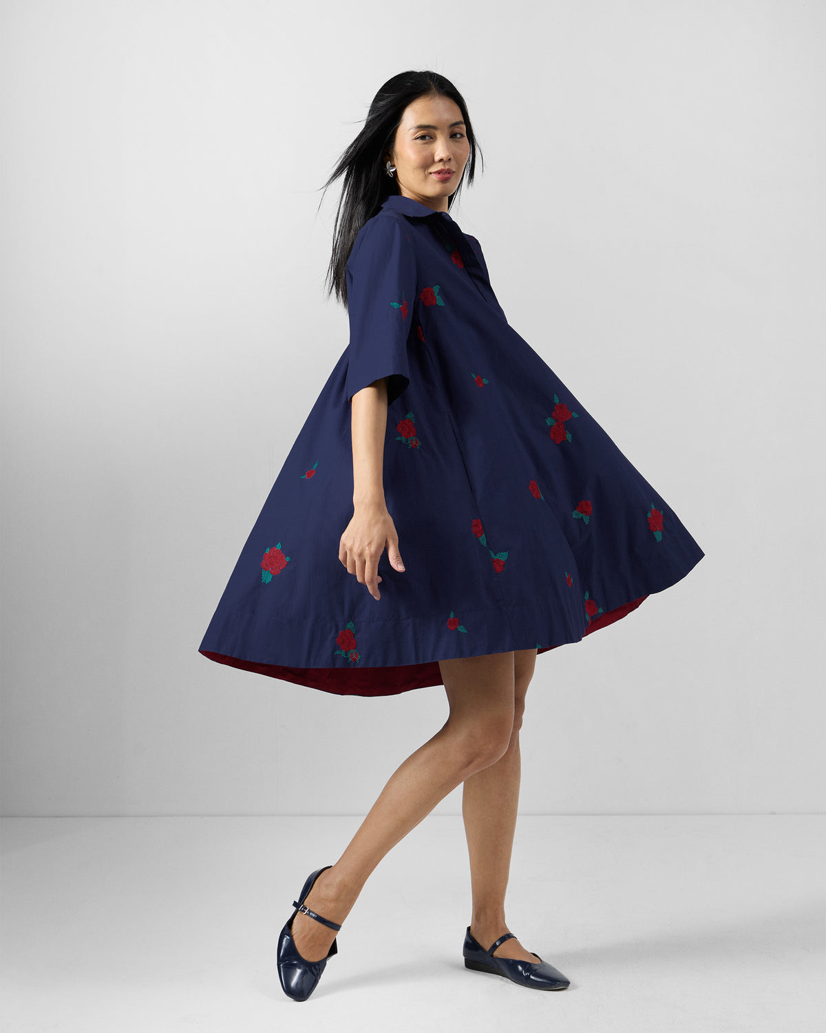 Ink blue Happy Heart Dress flaring to show A-line volume and rose embroidery.