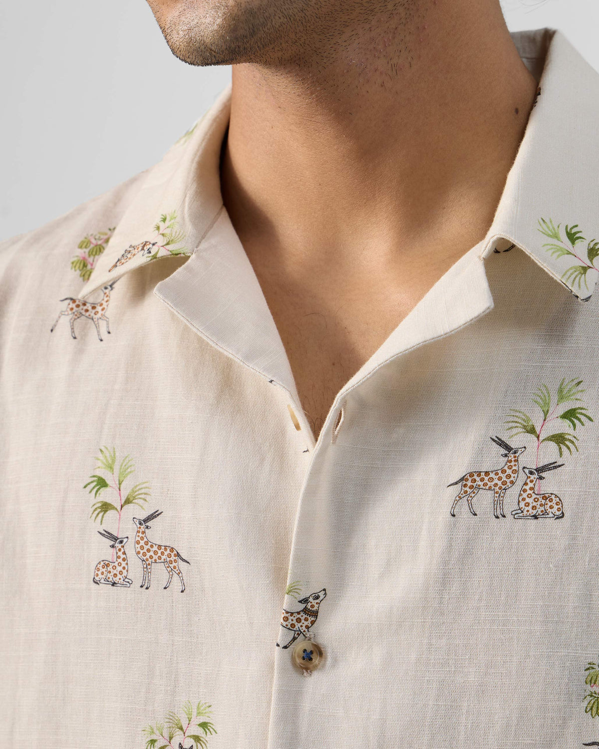 Close-up of a cream Bena shirt collar with gazelle print.