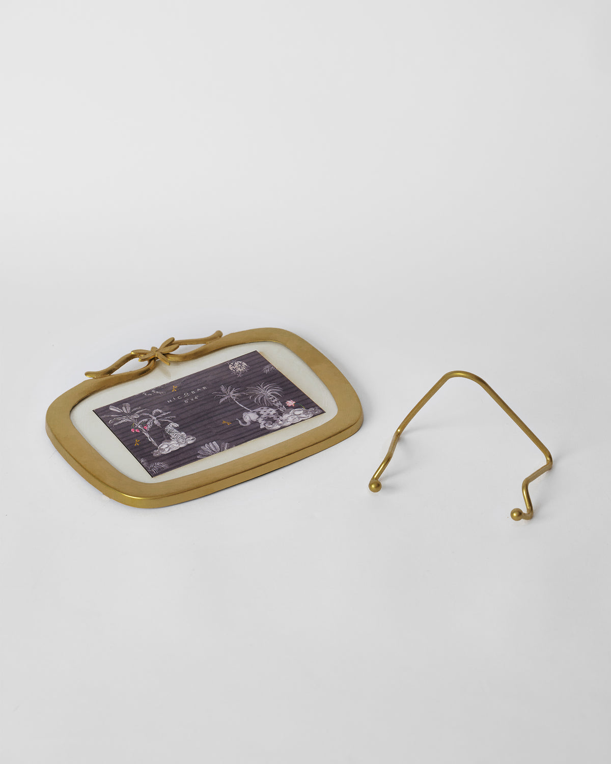 Gold Leap photo frame laid flat beside its separate wire stand.