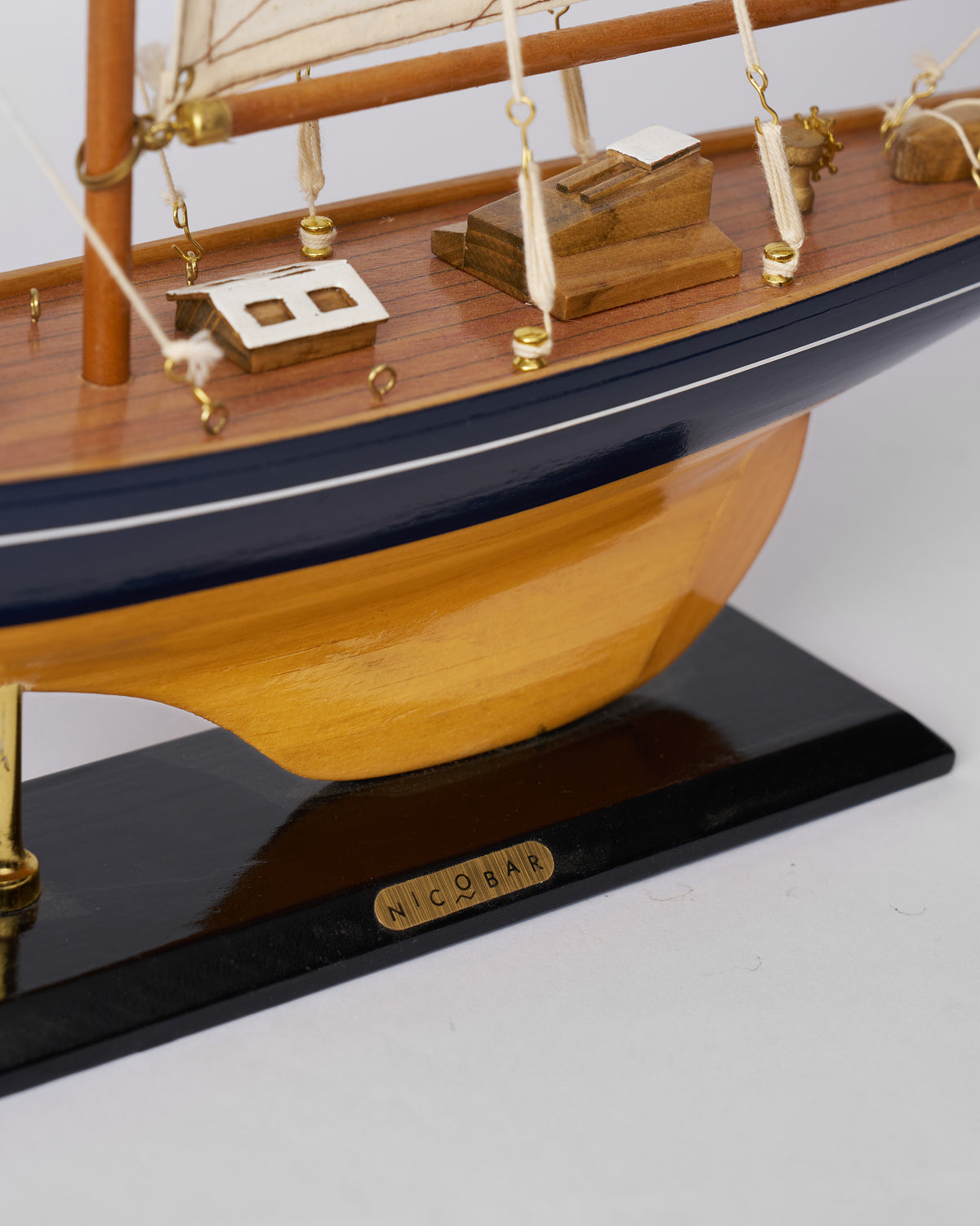 Close-up of the Sail Boat Home Accent stern showing its NICOBAR nameplate.
