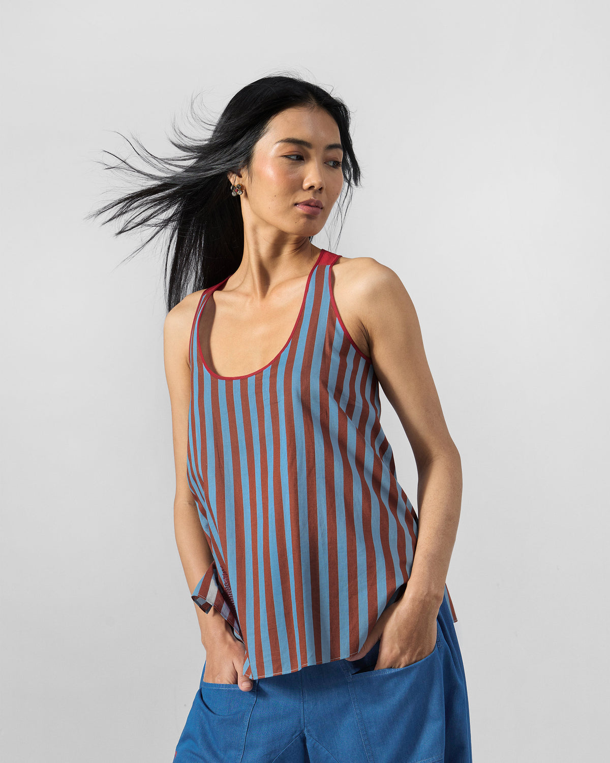 Person wearing a blue and brown striped Ukiyo racerback top.