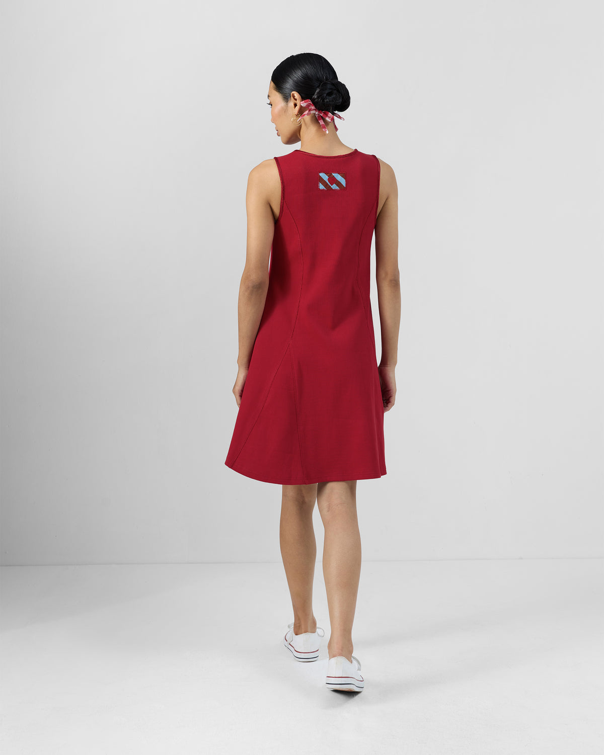 Back of a red Norva skater dress worn by a person.