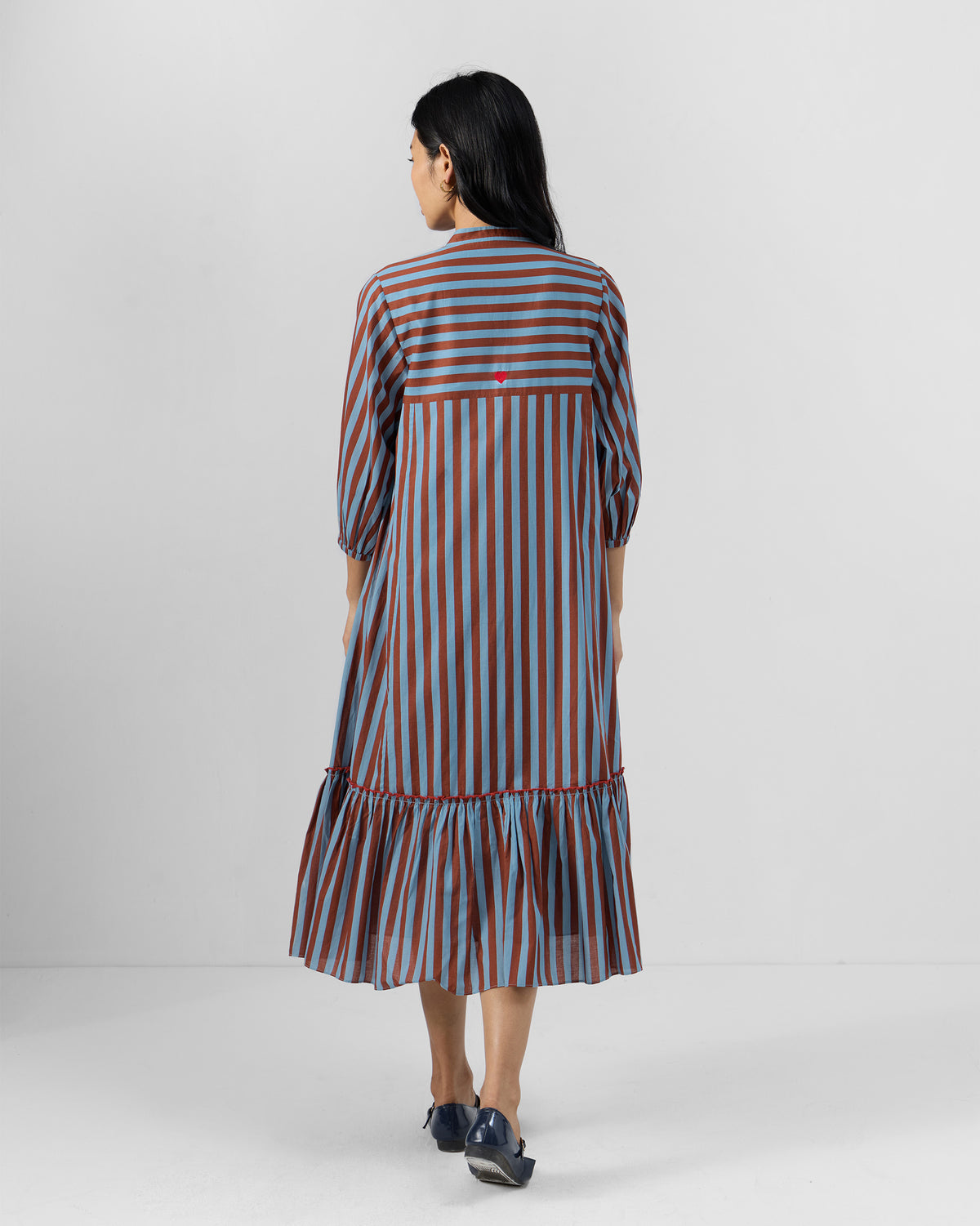 Back of a blue and brown striped Summer Tea dress with a ruffle hem.
