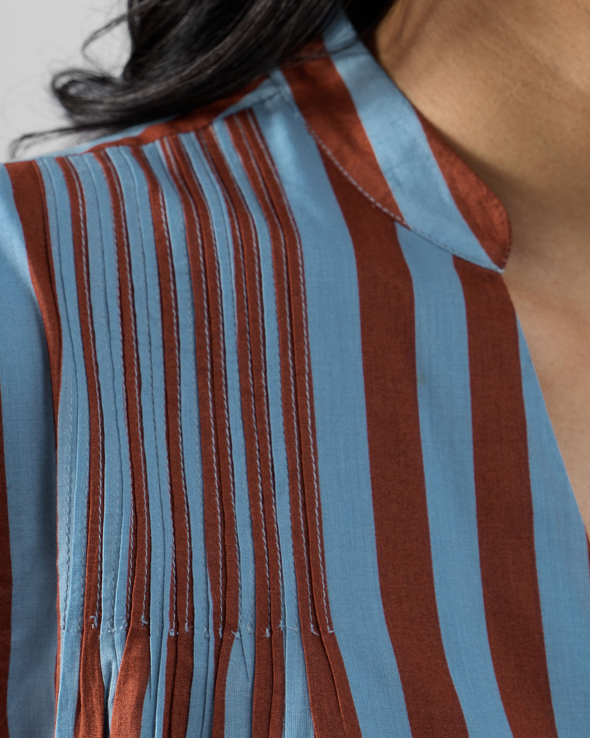 Close-up of shoulder pintucks on a blue and brown striped Summer Tea dress.