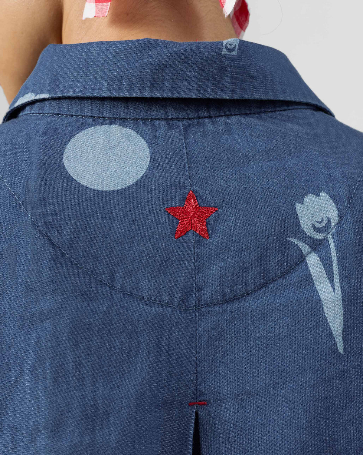 Close-up of a red embroidered star on the Happy Heart dress yoke.