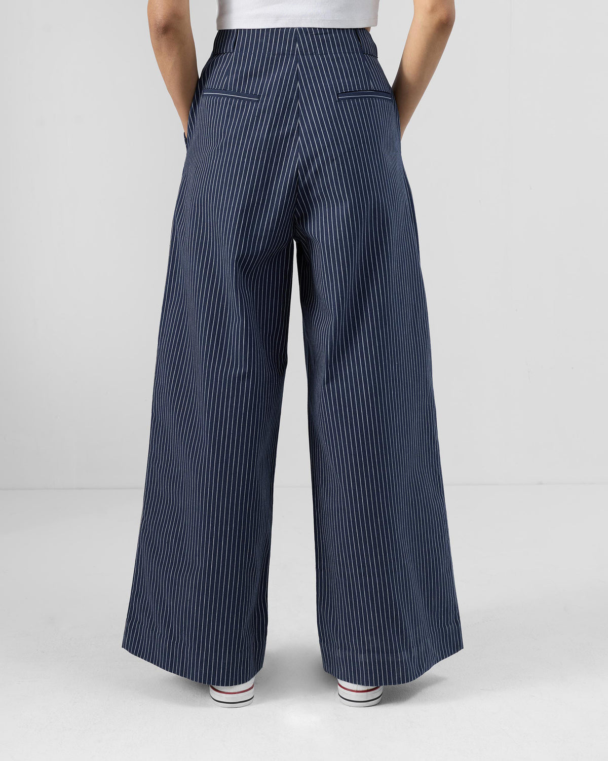 Back of navy striped Costa pants with welt pockets and belt loops.