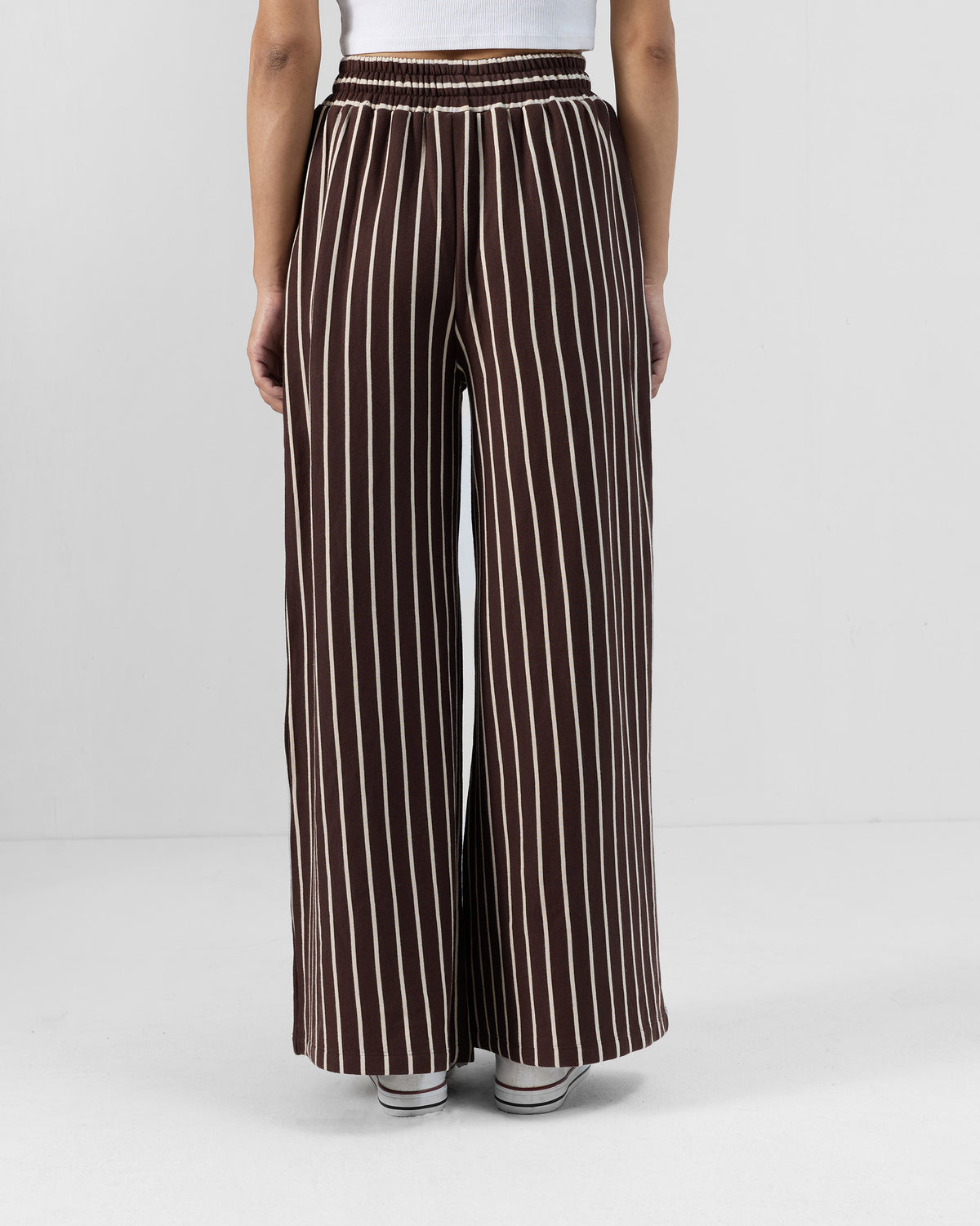 Back of brown and ivory Nova pants with an elastic waistband and wide legs.