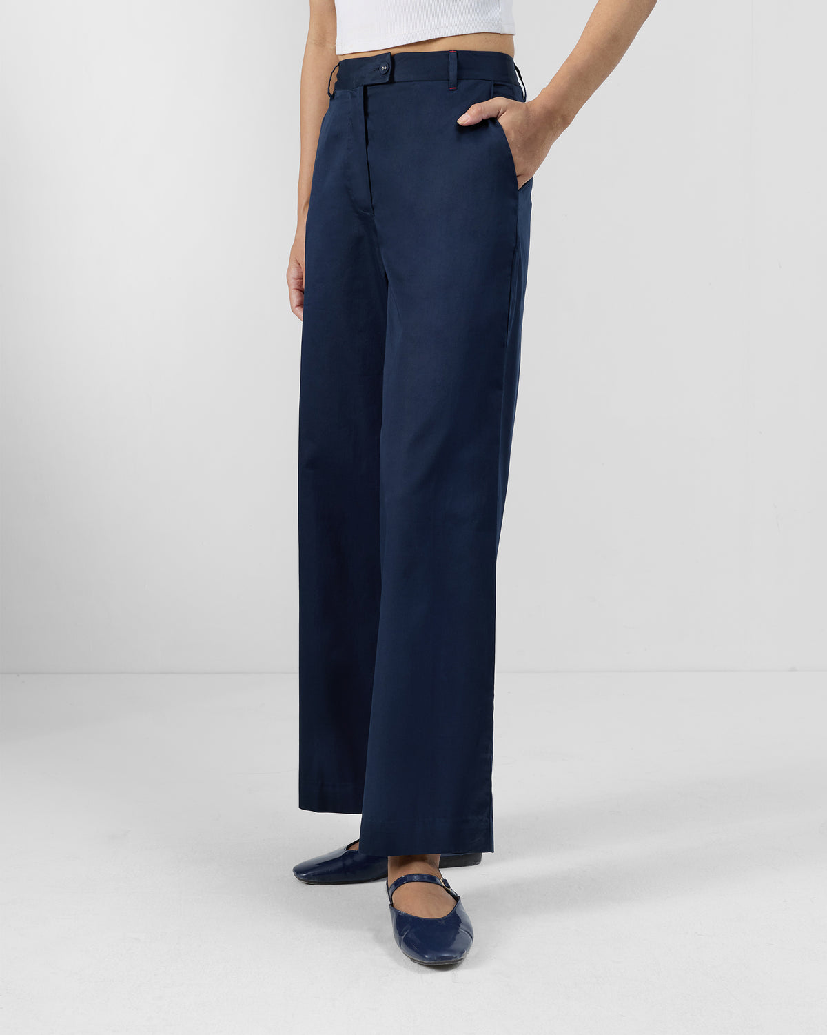Side view of navy Vita Pants with a wide-leg silhouette.
