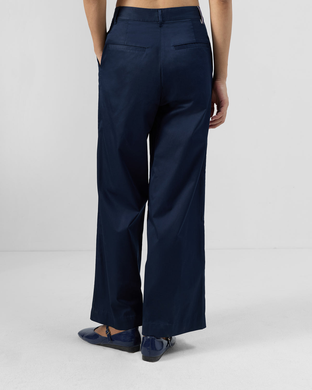 Back of navy Vita Pants with welt pockets.