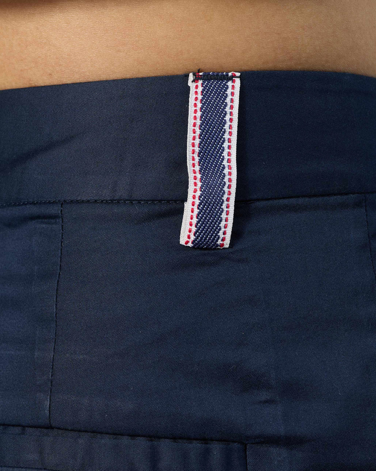 Close-up of a striped belt loop on navy Vita Pants.