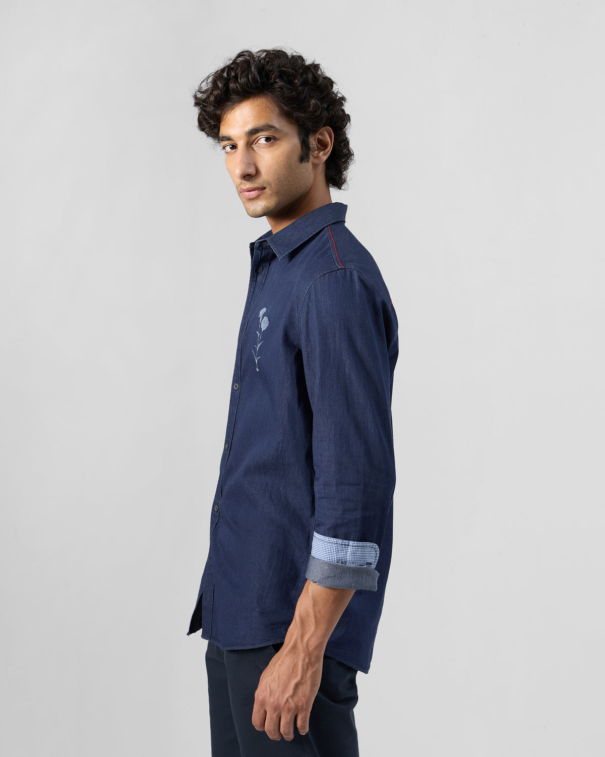 Side view of an indigo denim Classic shirt with a floral chest print.
