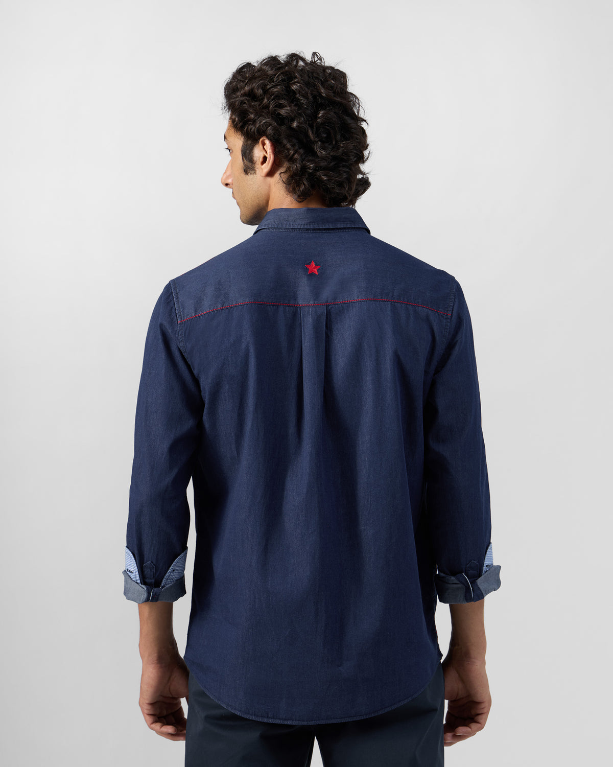 Back of an indigo denim Classic shirt with a red star.