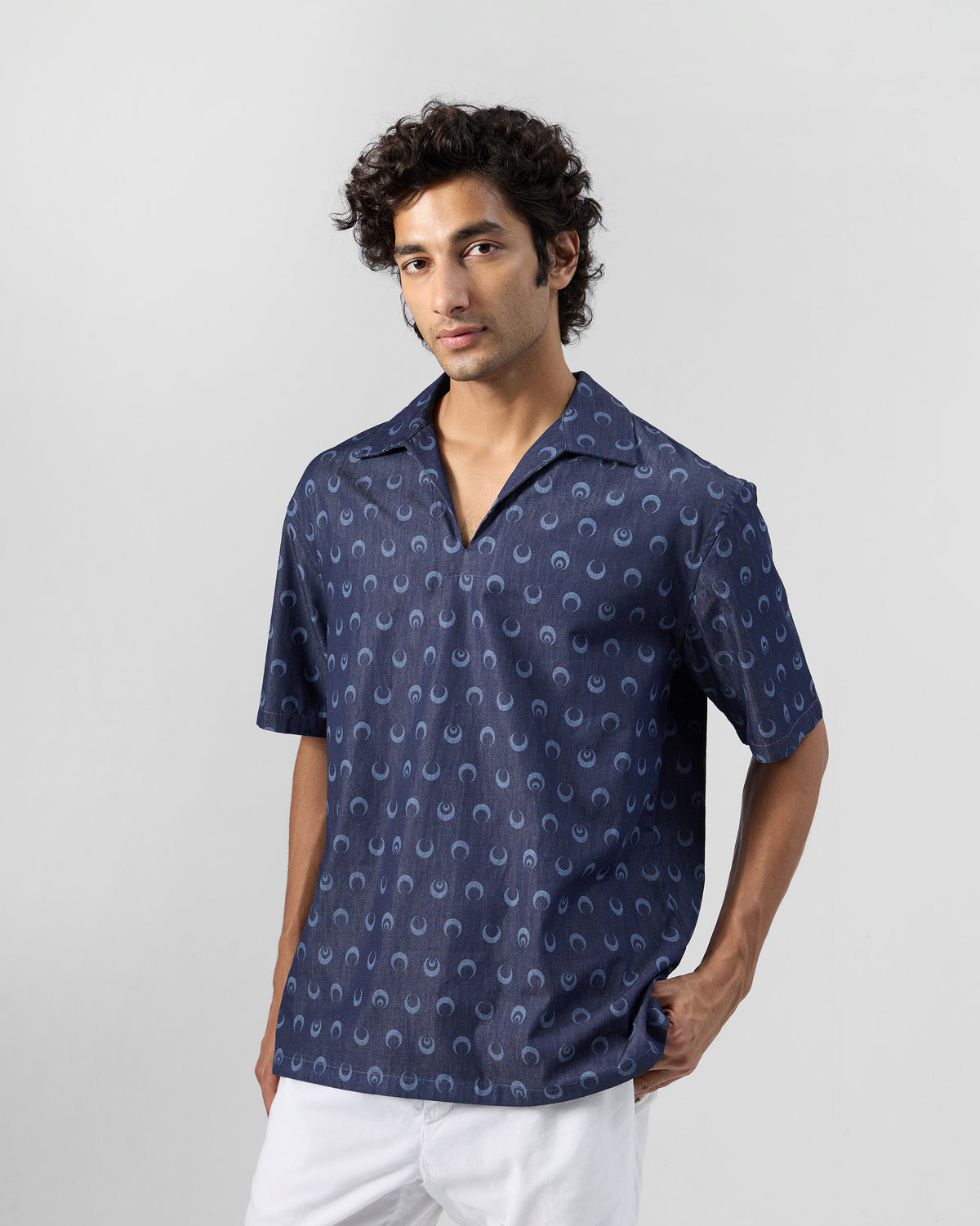 Indigo Yamuna kurta shirt with moon print worn open at the collar.