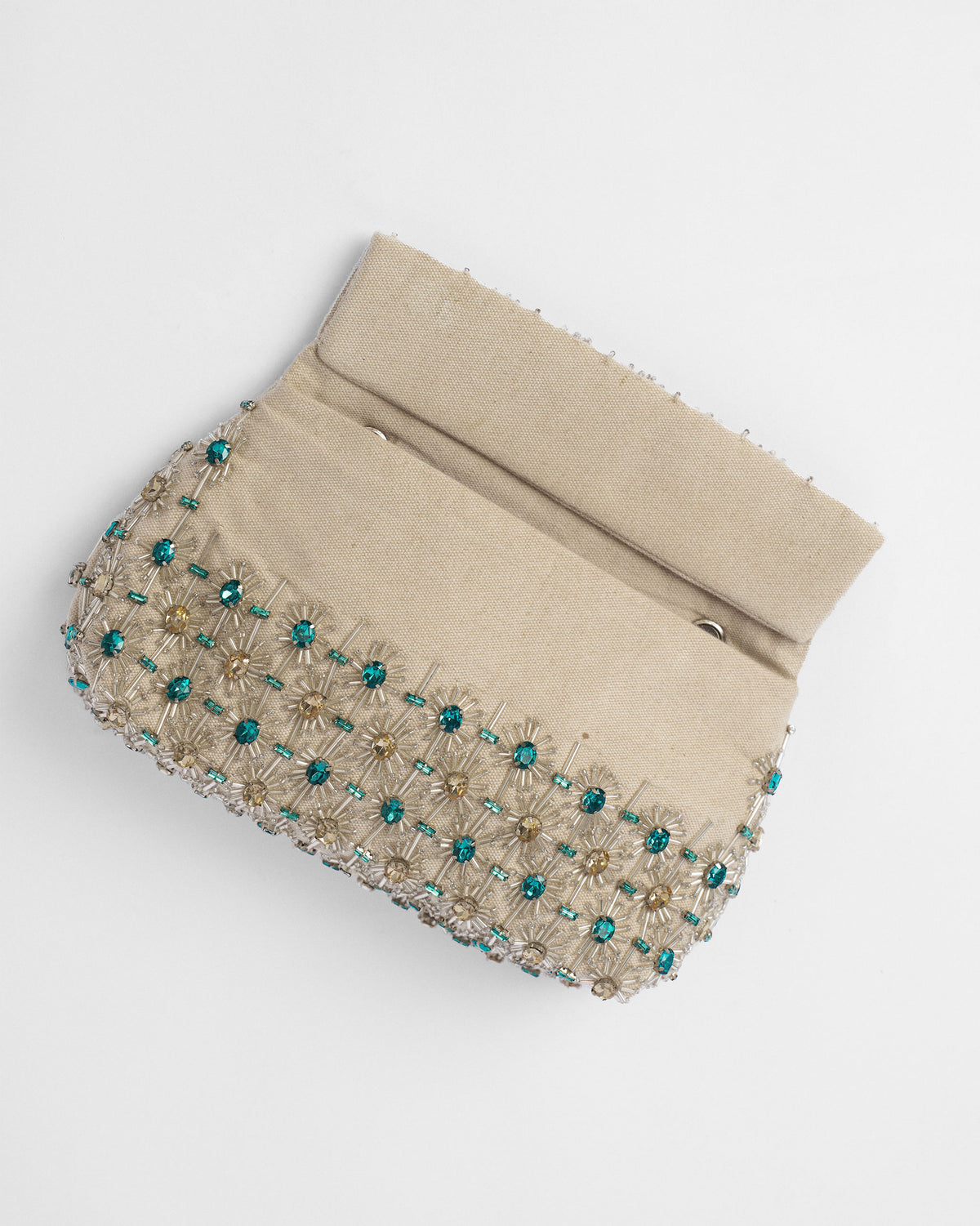 Open ivory Noor Clutch showing the lining and silver D-rings.