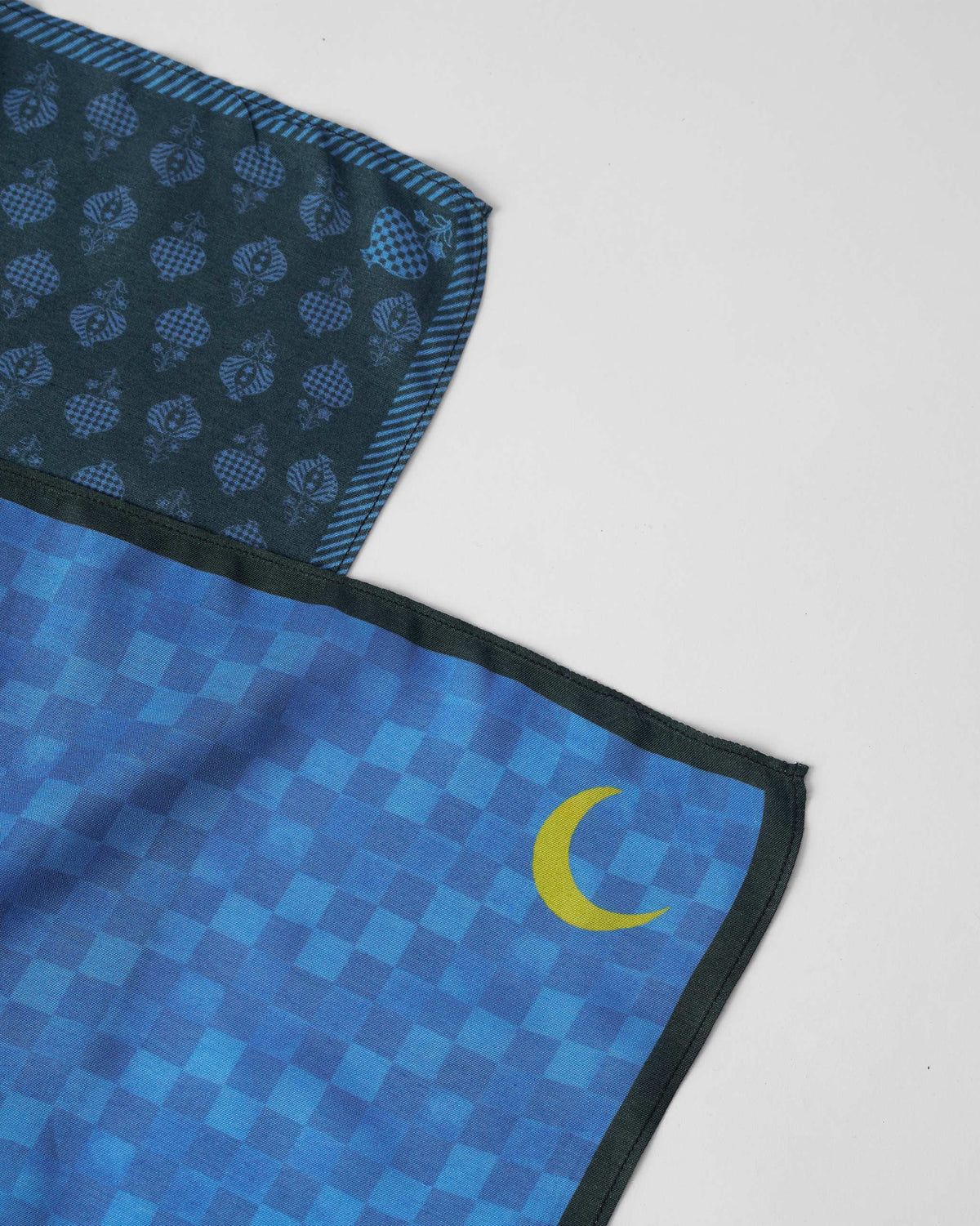 Close-up of blue Twilight Pocket Squares showing a yellow crescent and buta print.