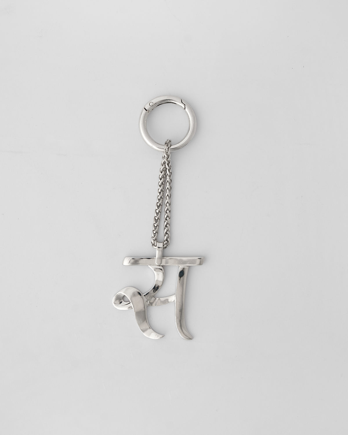 Alphabet S Bag Charm in silver hanging upright from its clasp ring.