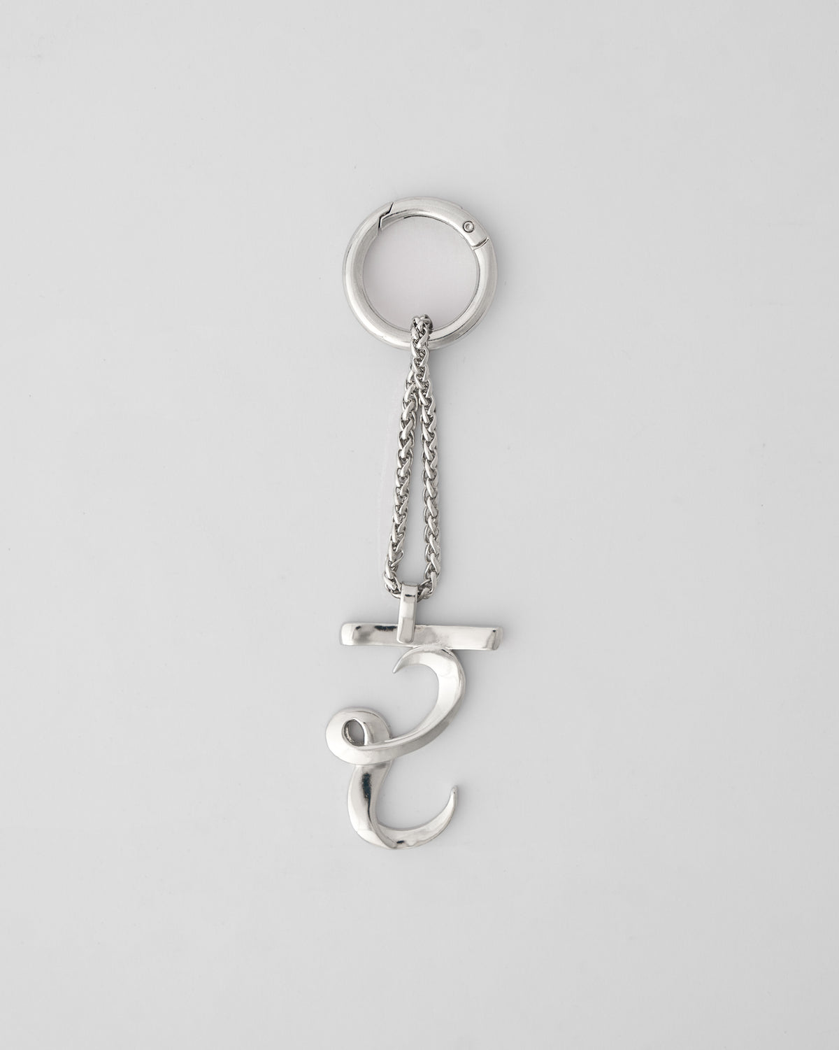 Alphabet R Bag Charm in silver hanging upright from its clasp ring.
