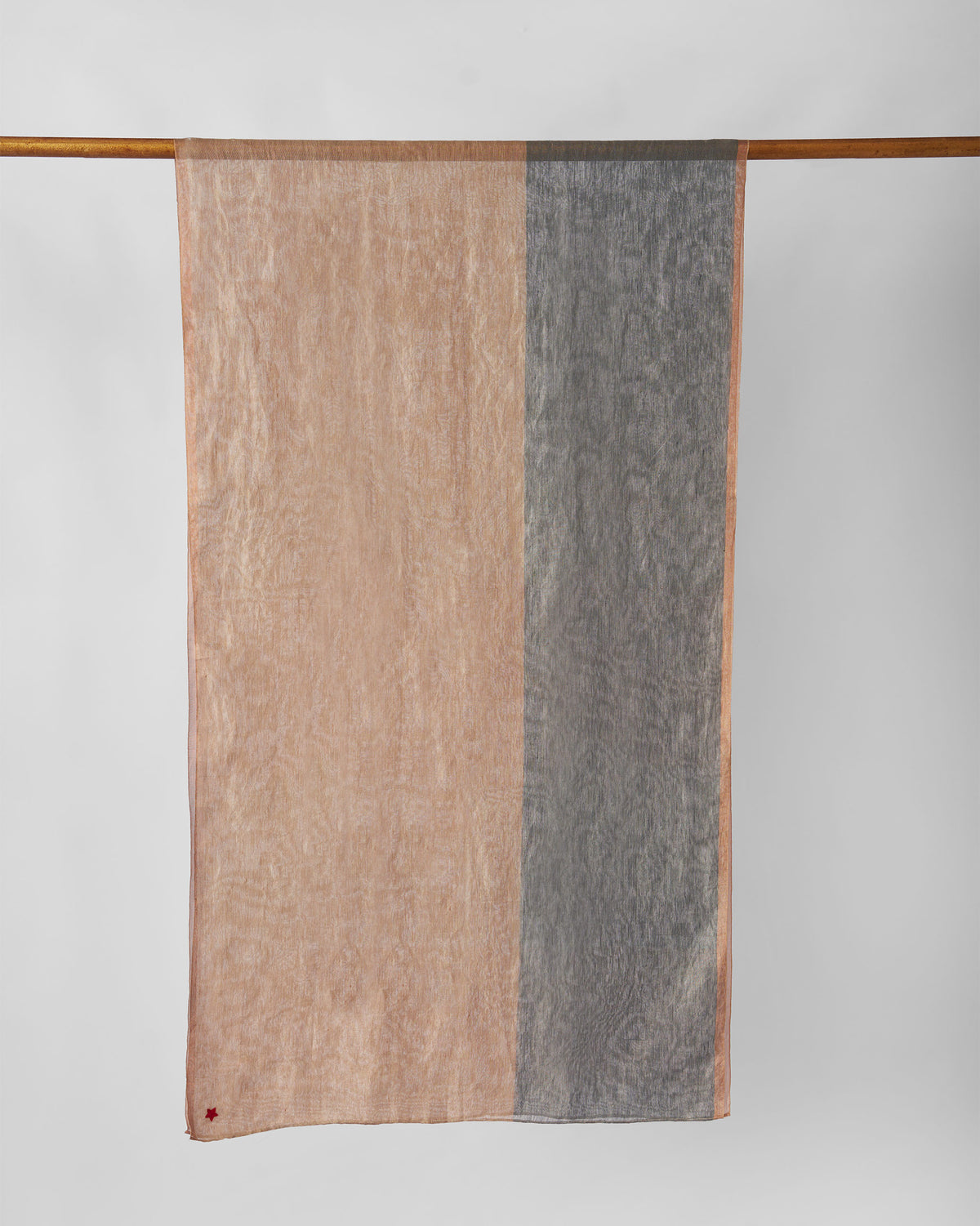 Astral Scarf in gold and grey hanging full length from a wooden rod.