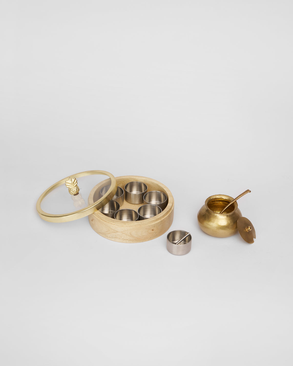 Wooden Chand Madhu spice box with glass lid and brass ghee pot.