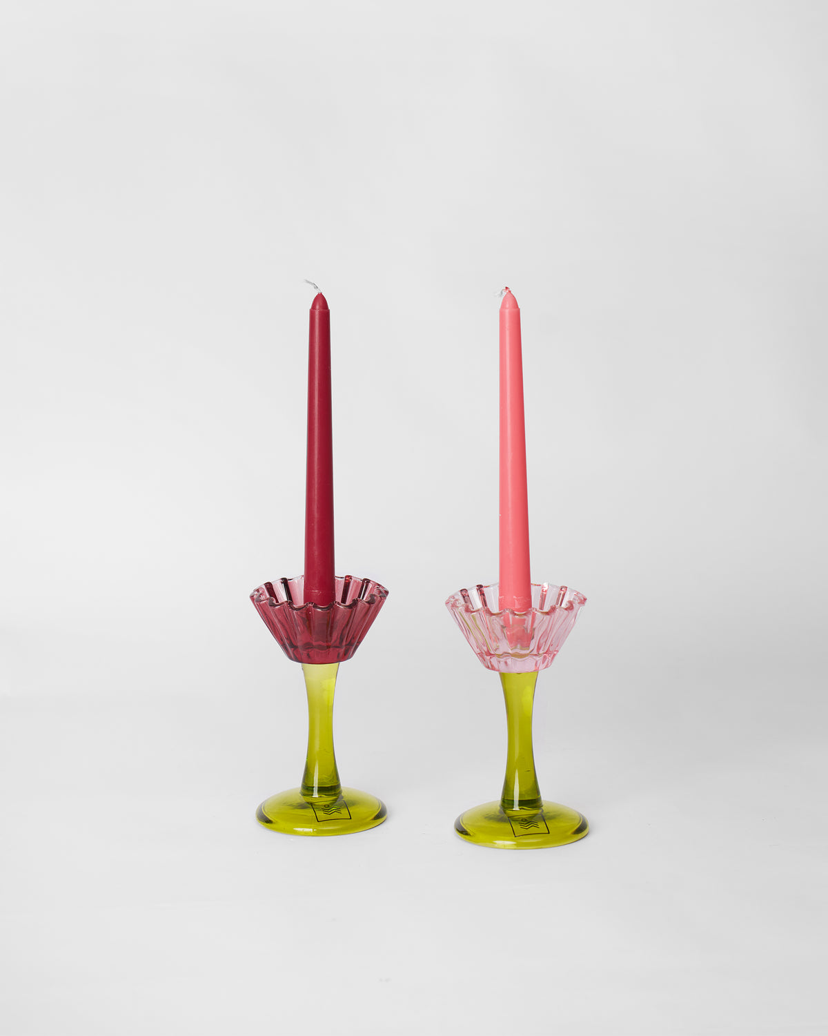 Pair of Ember candle holders with red and coral taper candles in place.