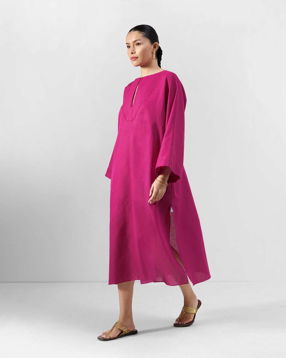 Person wearing a berry pink Nihra Kaftan with a loose A-line shape.