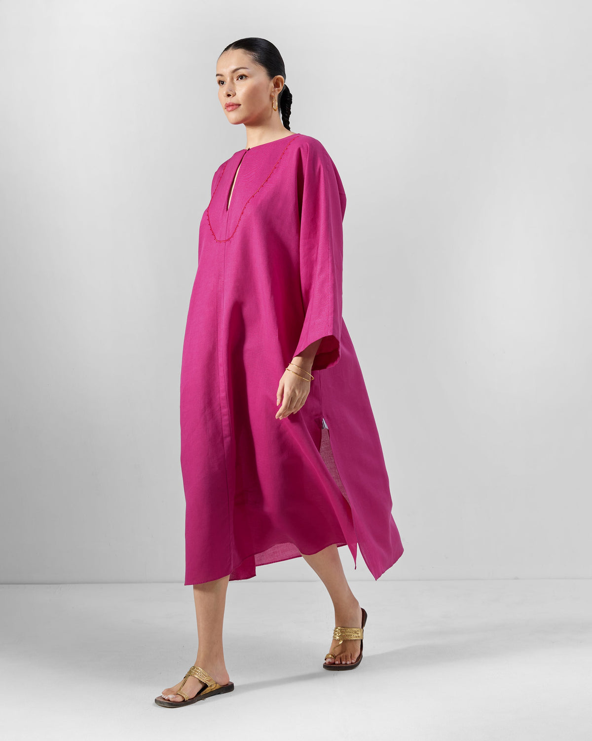 Person wearing a berry pink Nihra Kaftan with a keyhole neckline.