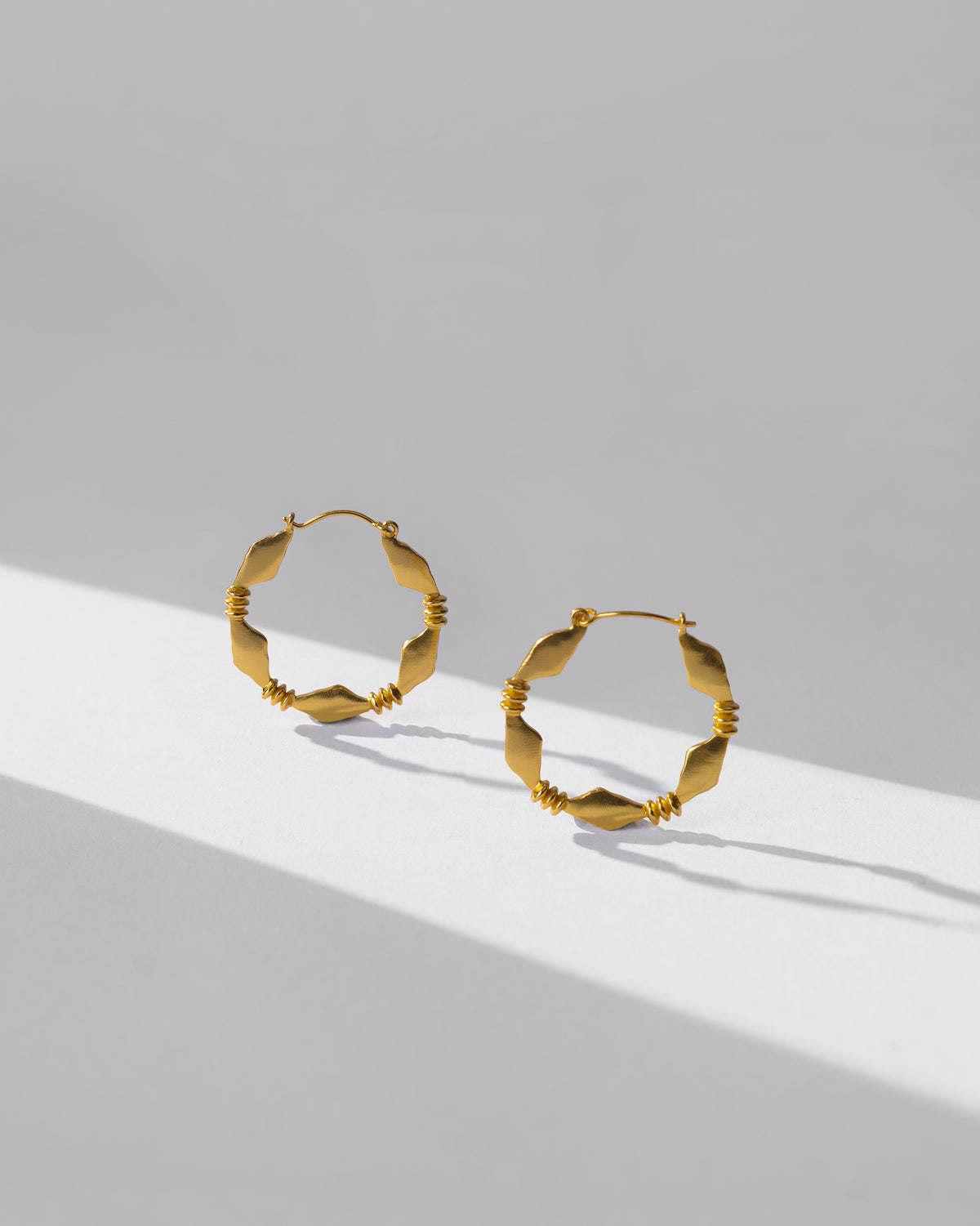 Pair of gold Pillar balis with diamond-shaped segments.