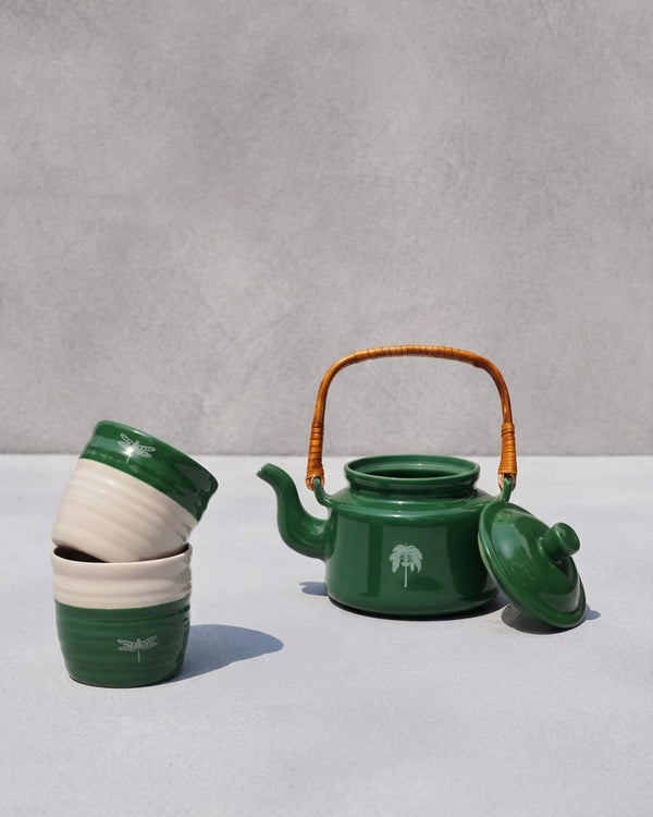 The tumblers stacked beside the teapot