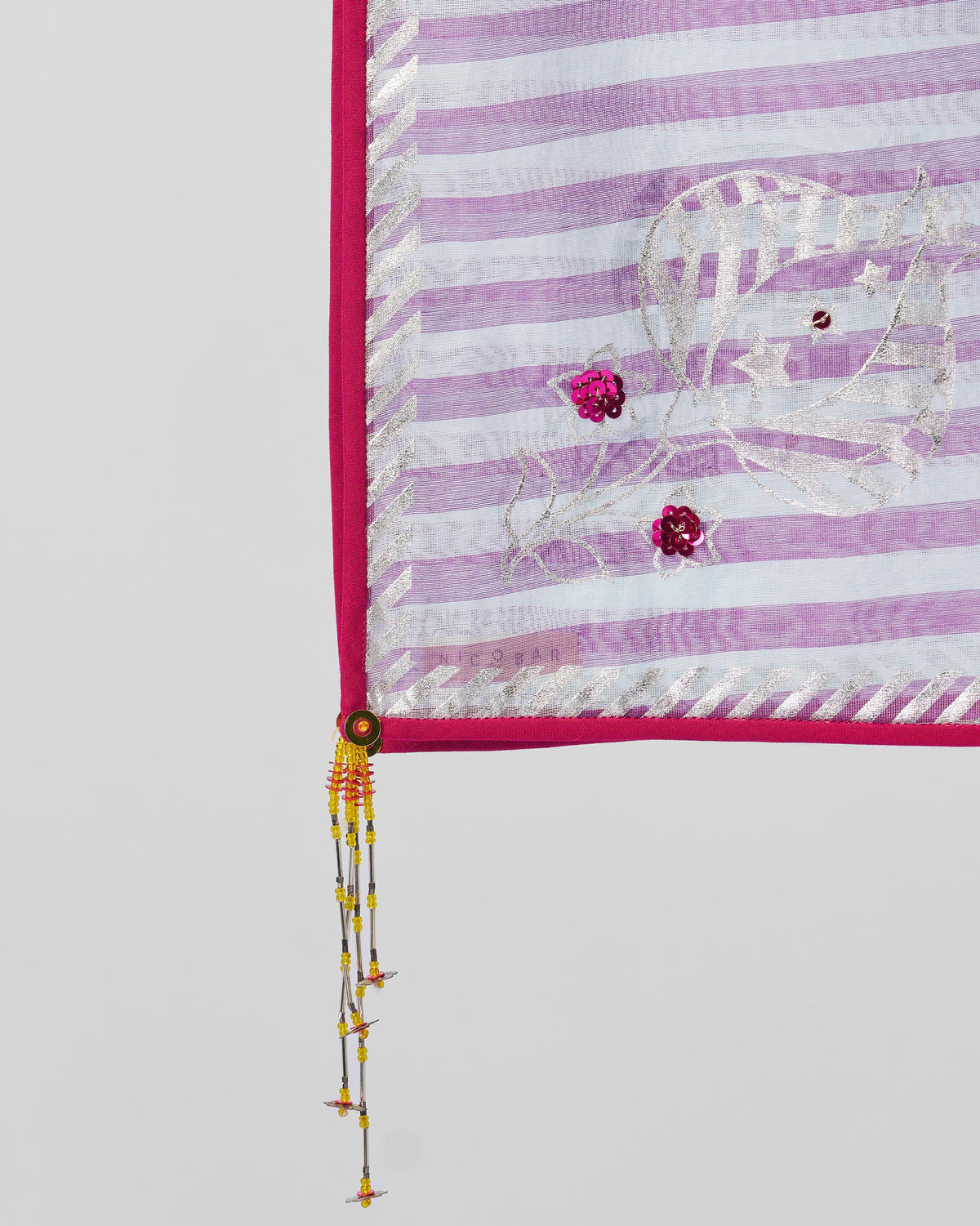 Close-up of a Vana dupatta showing sequin flowers and beaded tassels.