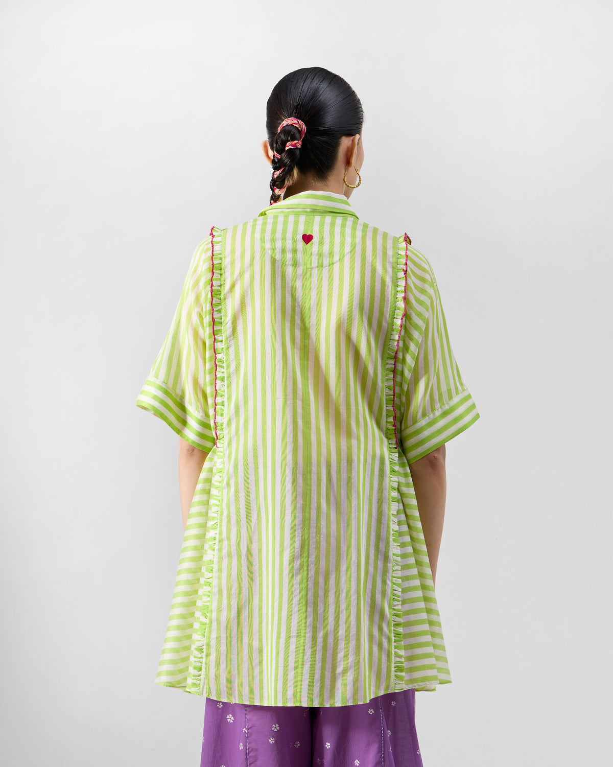 Back of a lime and ivory Manoor Top with a red embroidered heart.
