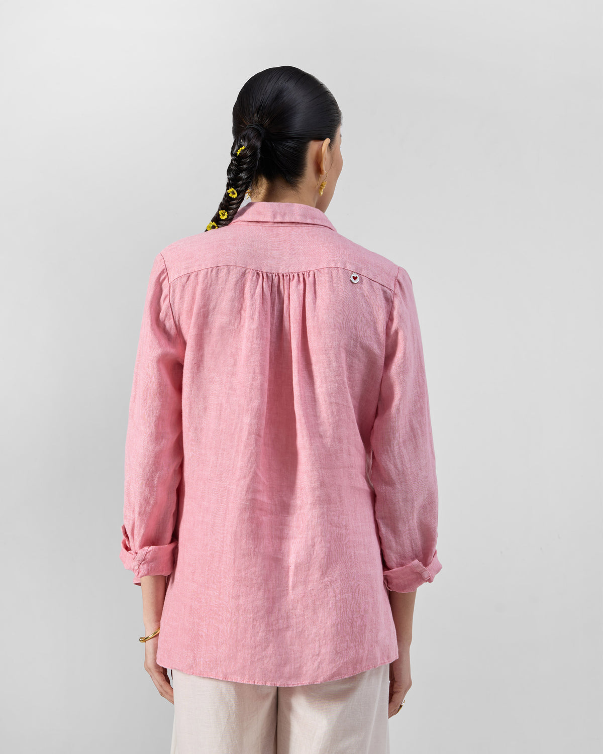 Back of a soft pink Mati linen shirt with a gathered yoke.