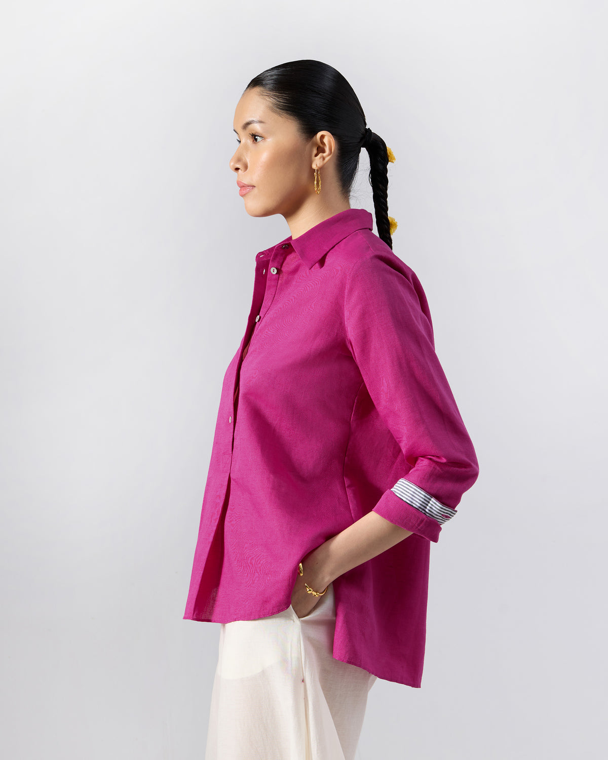 Side view of a berry pink Mati shirt with striped cuff lining.