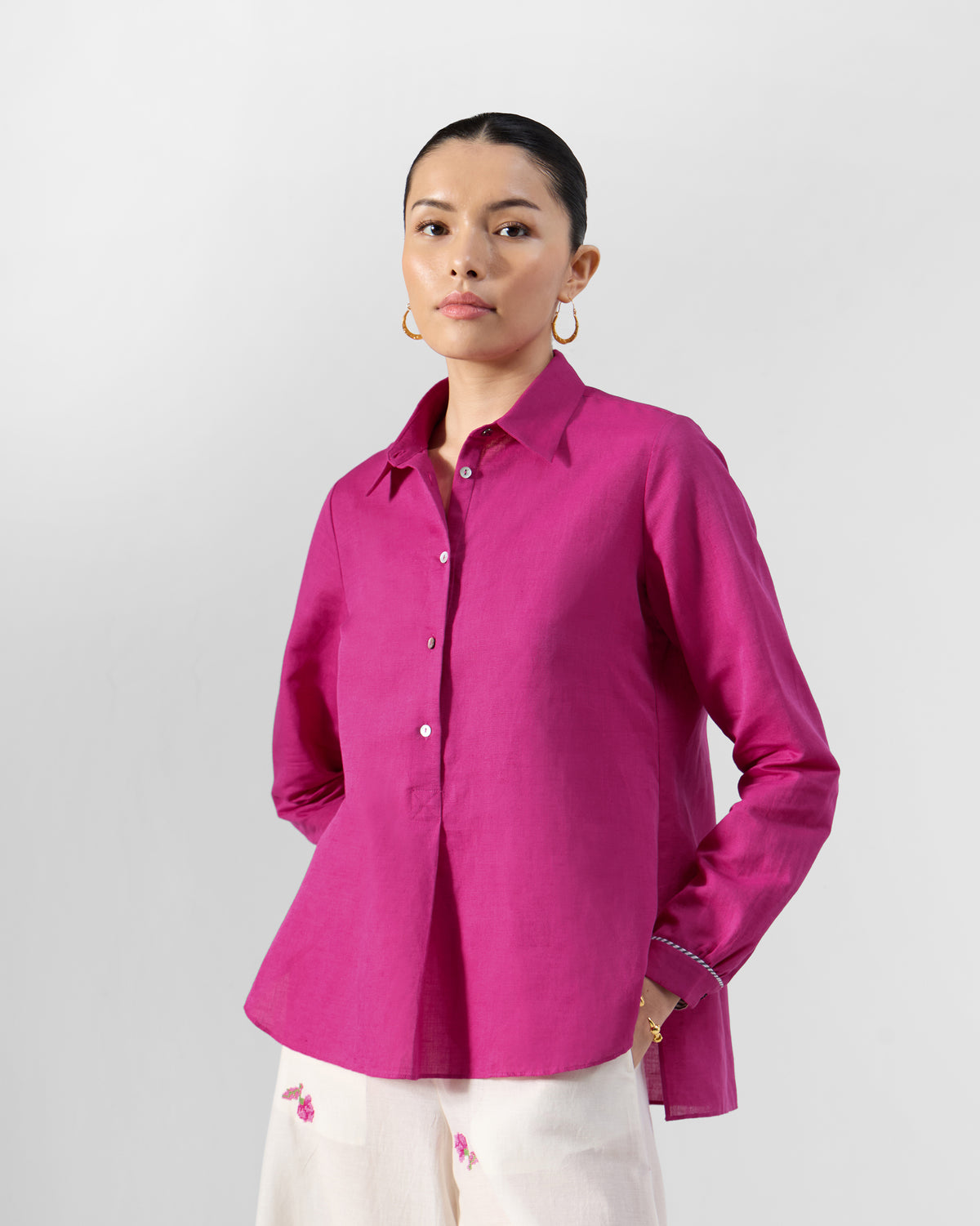 Person wearing a berry pink Mati shirt.