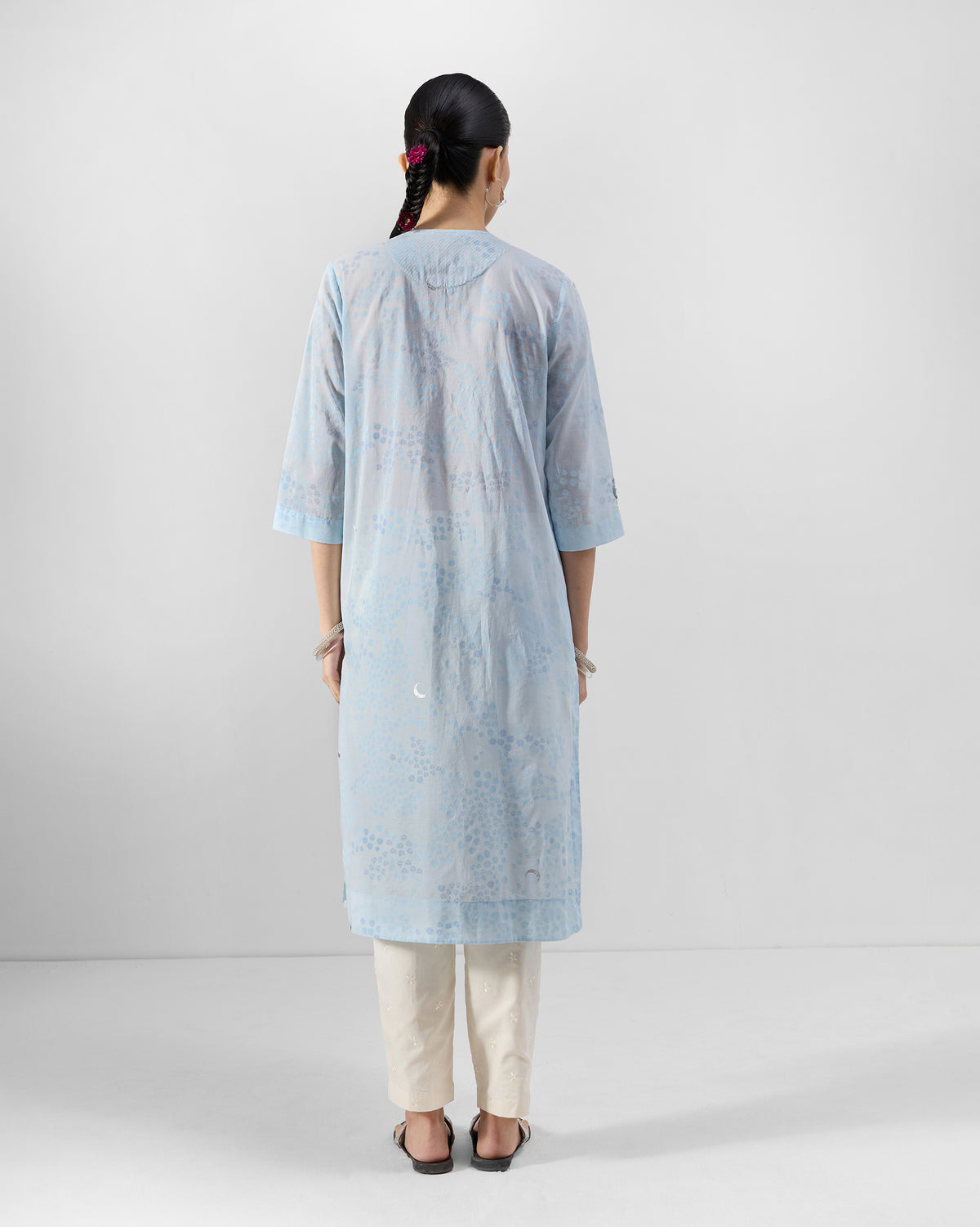 Back of a light blue printed kurta with a moon motif.