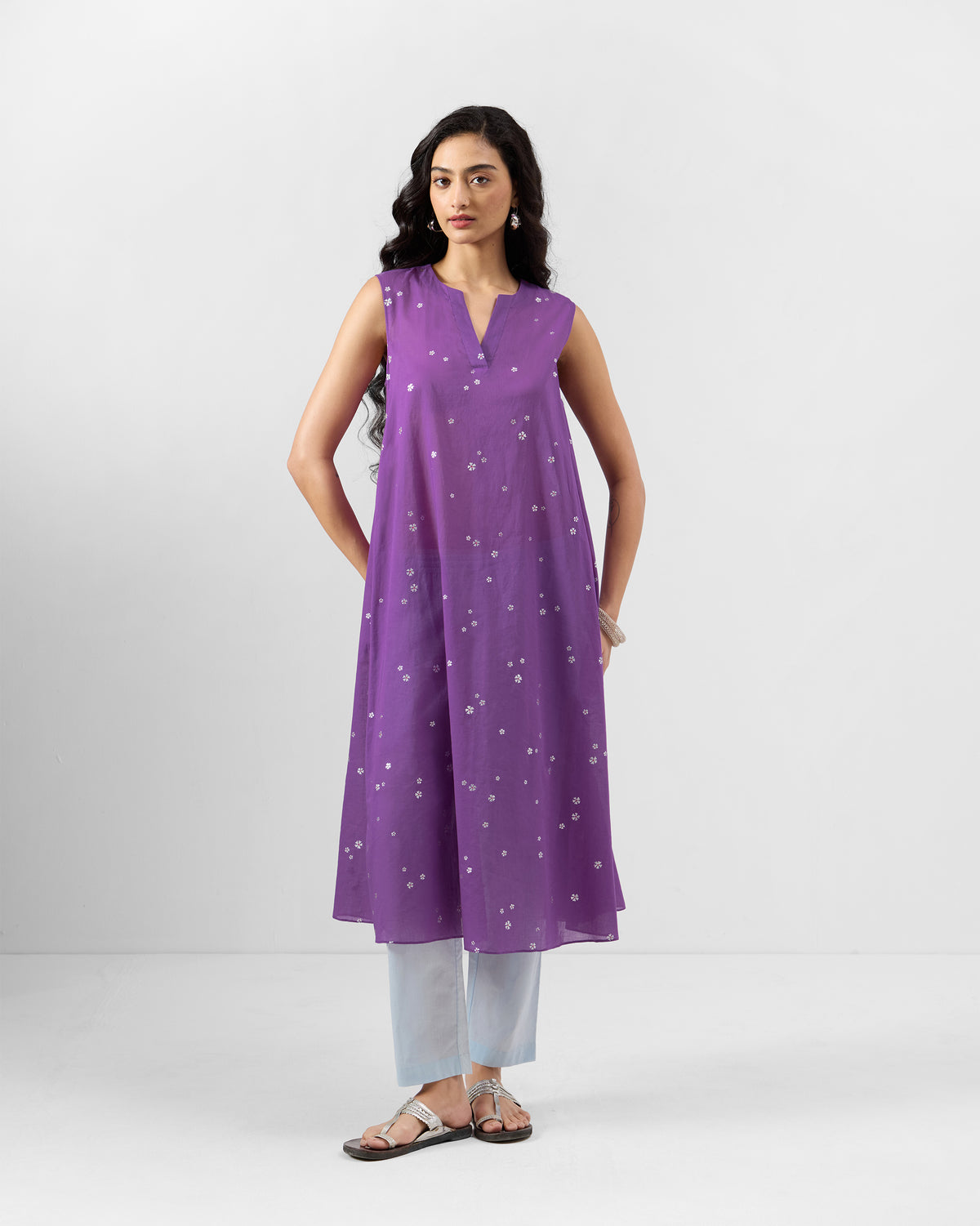 Person wearing a purple printed Tuni kurta with a notched V-neck.