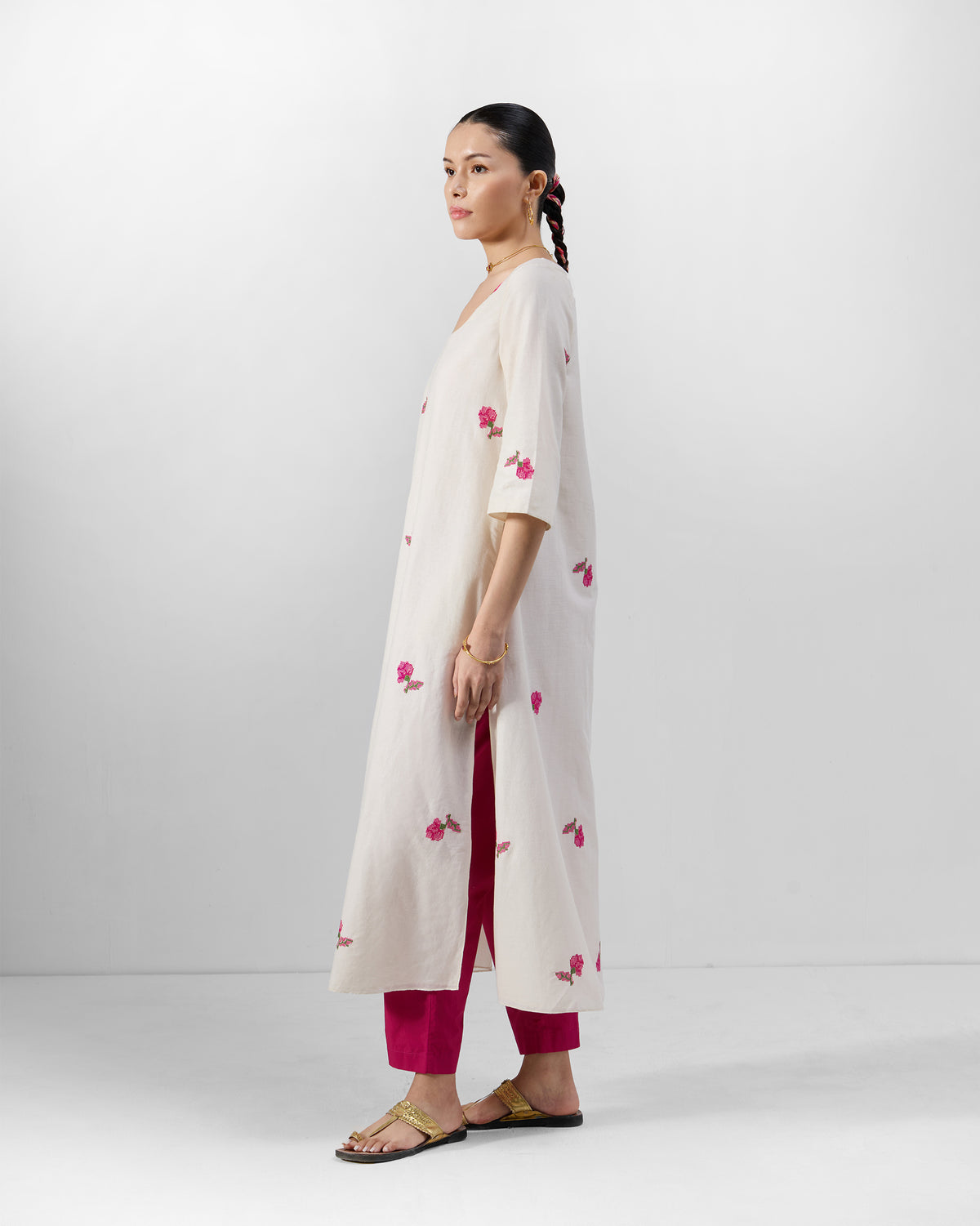 Side view of a cream Amrai Kurta with pink floral embroidery.