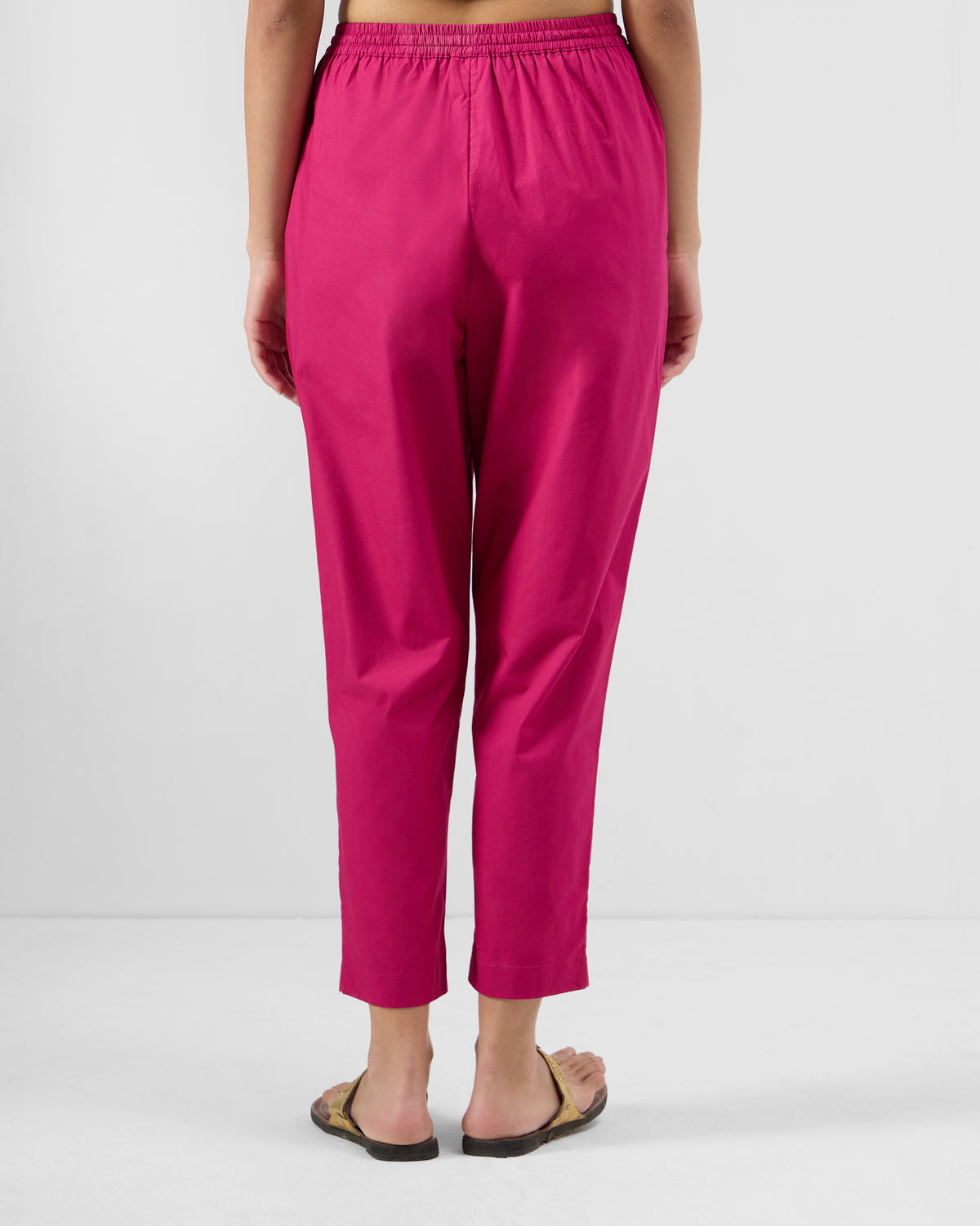 Back of berry pink Kintara pants with a gathered elastic waistband.