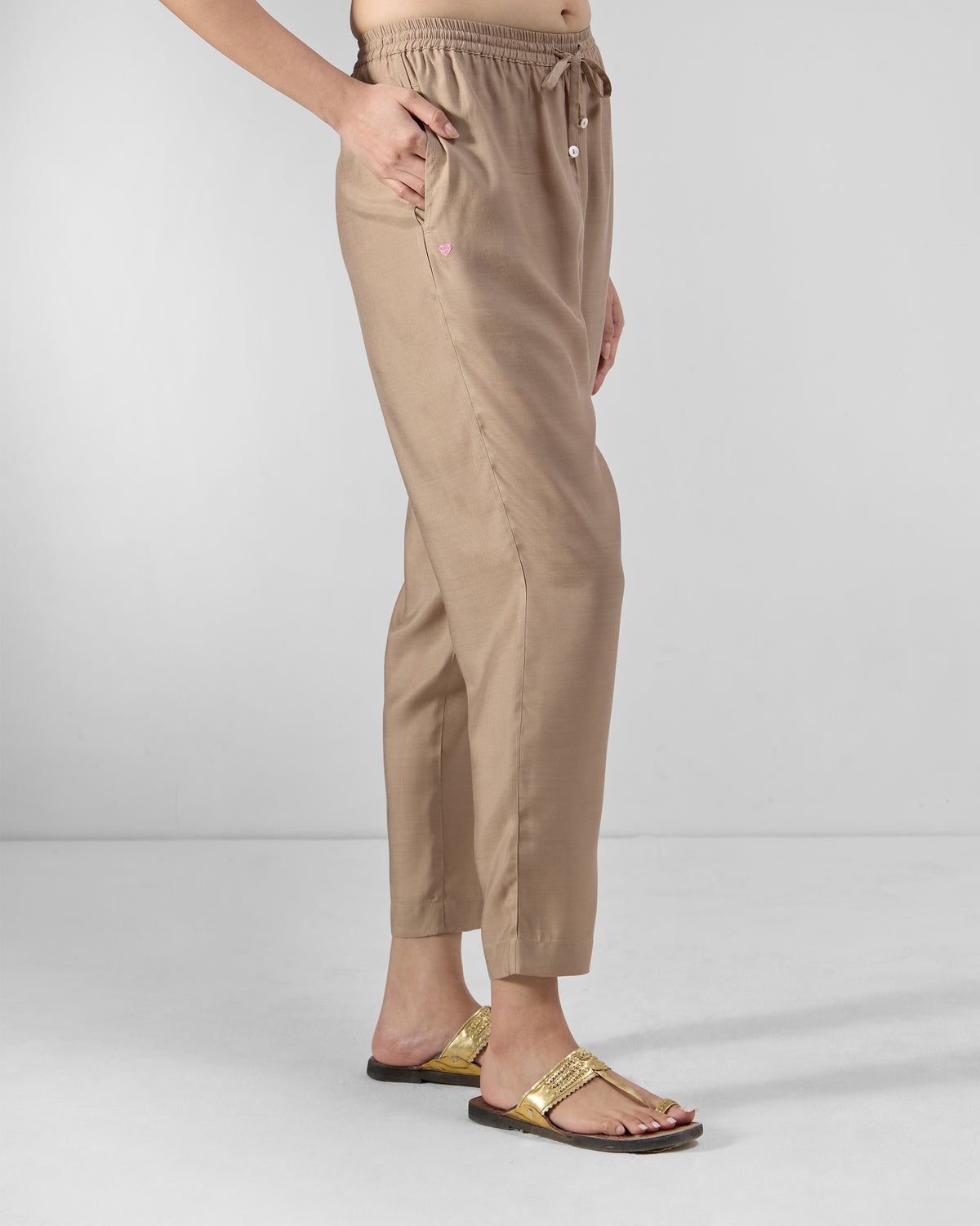 Side view of sand Bemberg narrow pants showing a tapered cropped fit.