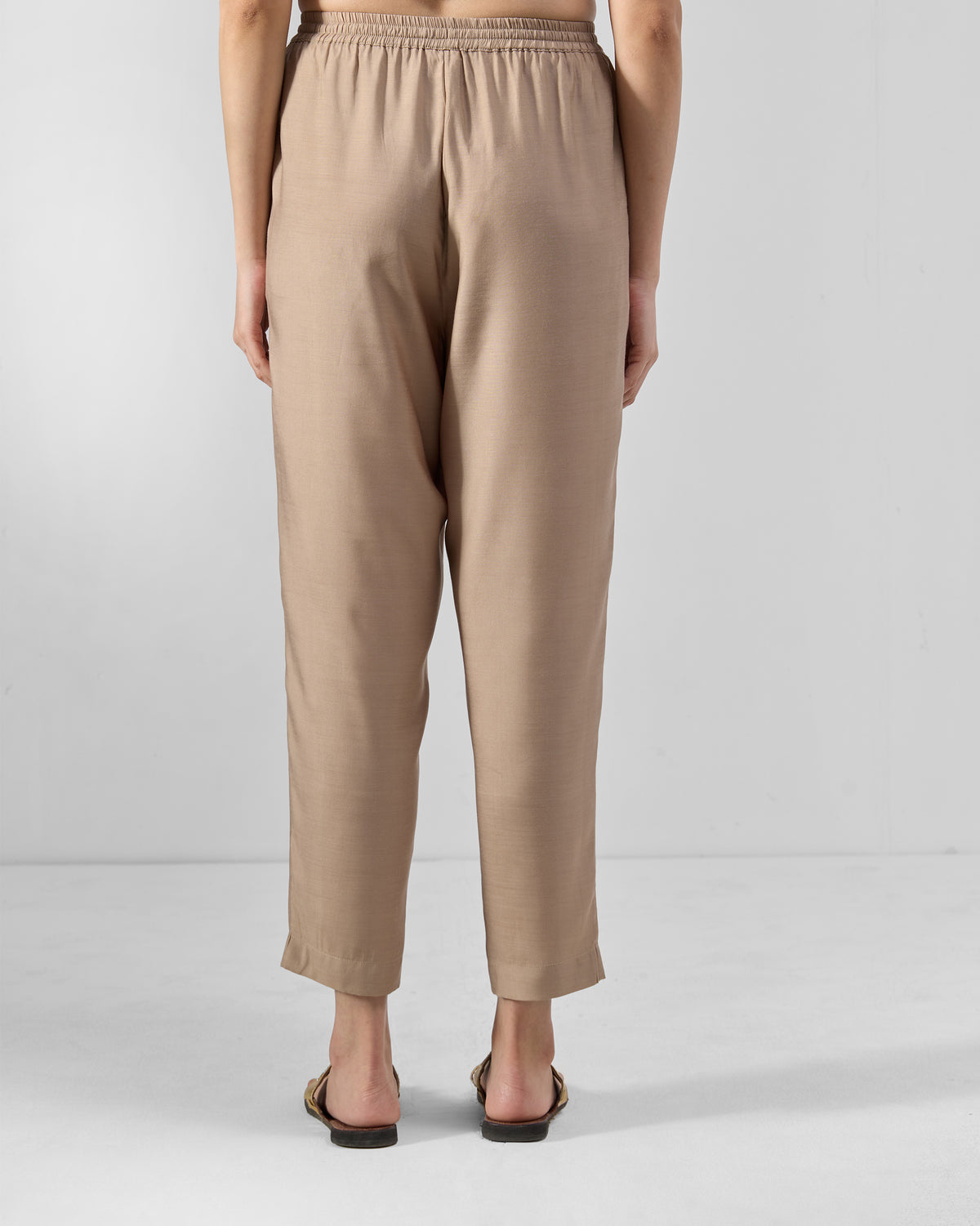 Back of sand Bemberg narrow pants with a gathered elastic waistband.