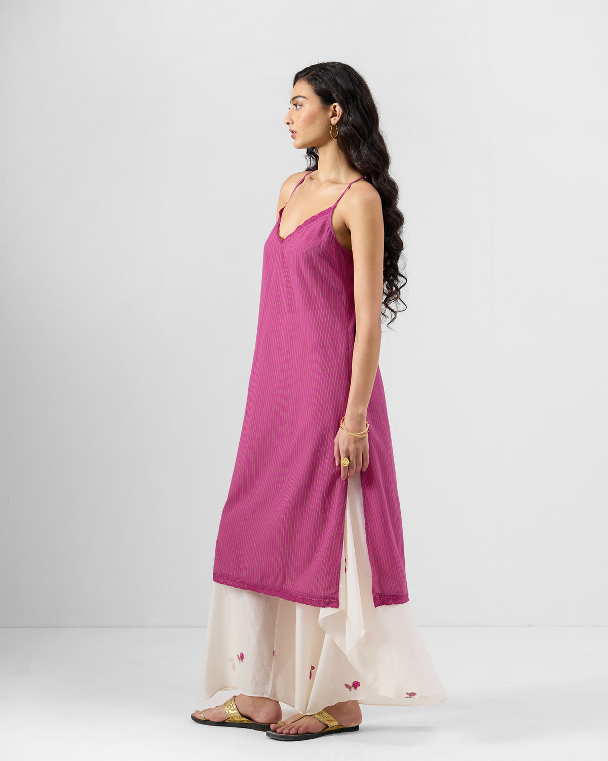 Side view of a rouge pink Kova Slip with lace trim and an A-line fit.