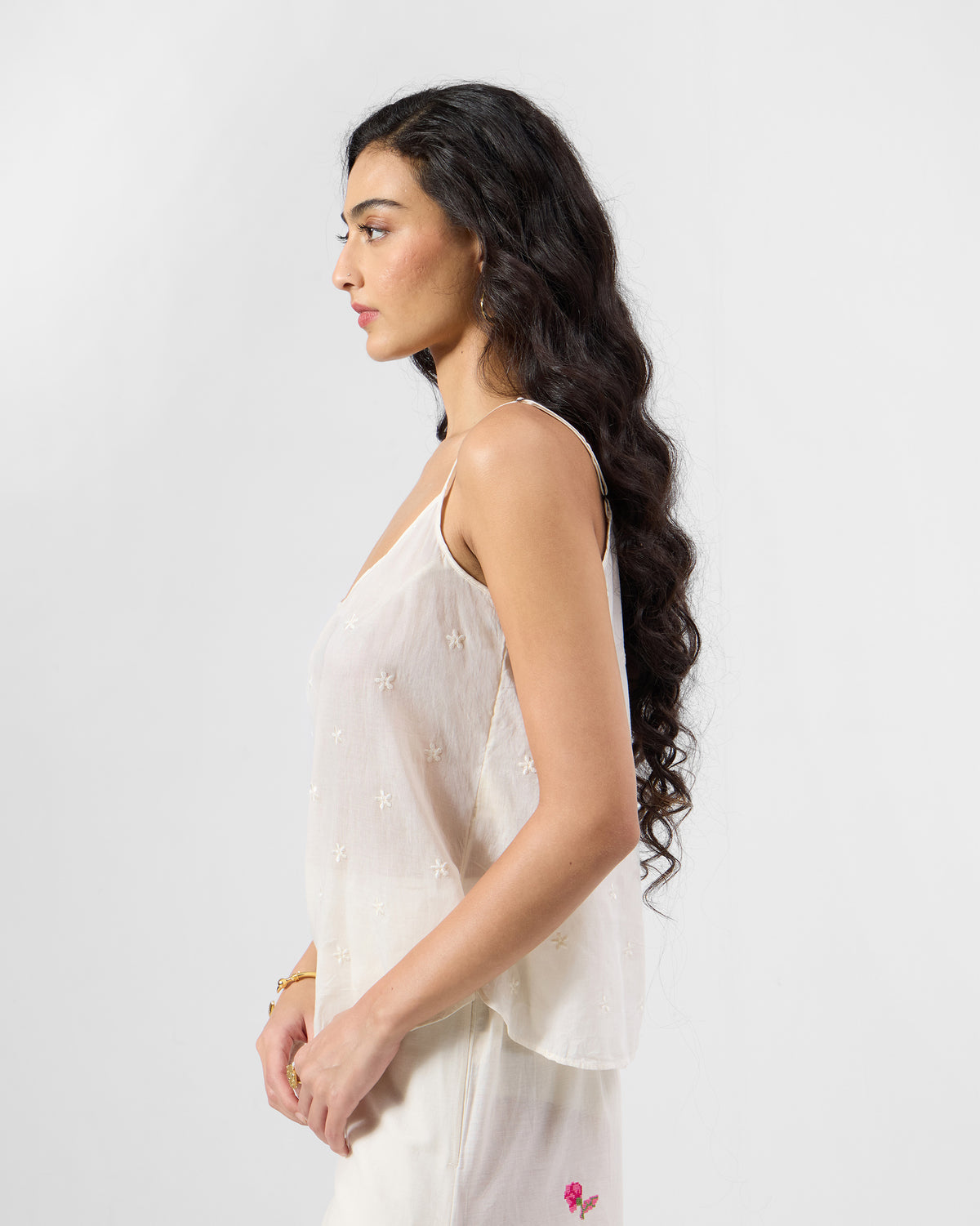Side view of an ivory embroidered Lola slip with thin spaghetti straps.