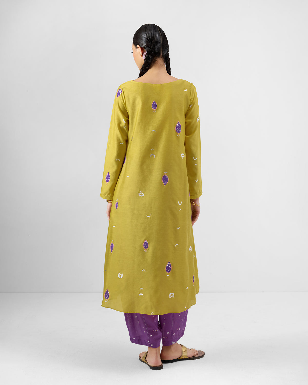 Back of a chartreuse Boat Neck Kurta with purple motifs worn by a person.