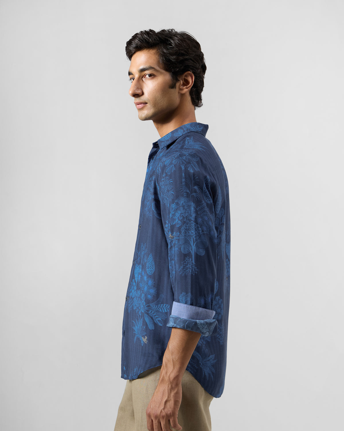 Side view of a navy Hakuna shirt with a tonal botanical print.