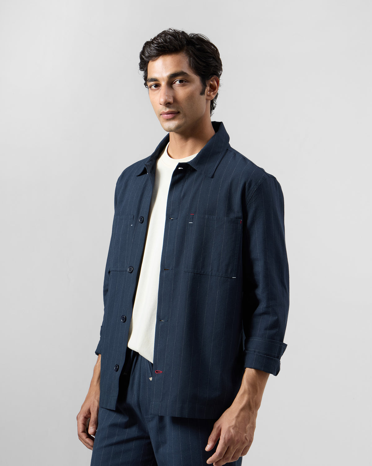 Navy pinstripe Rayh shacket with red bartack accents on the pocket.