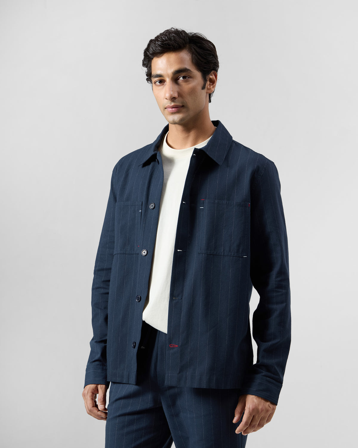 Navy pinstripe Rayh shacket with twin patch pockets and red bartacks.